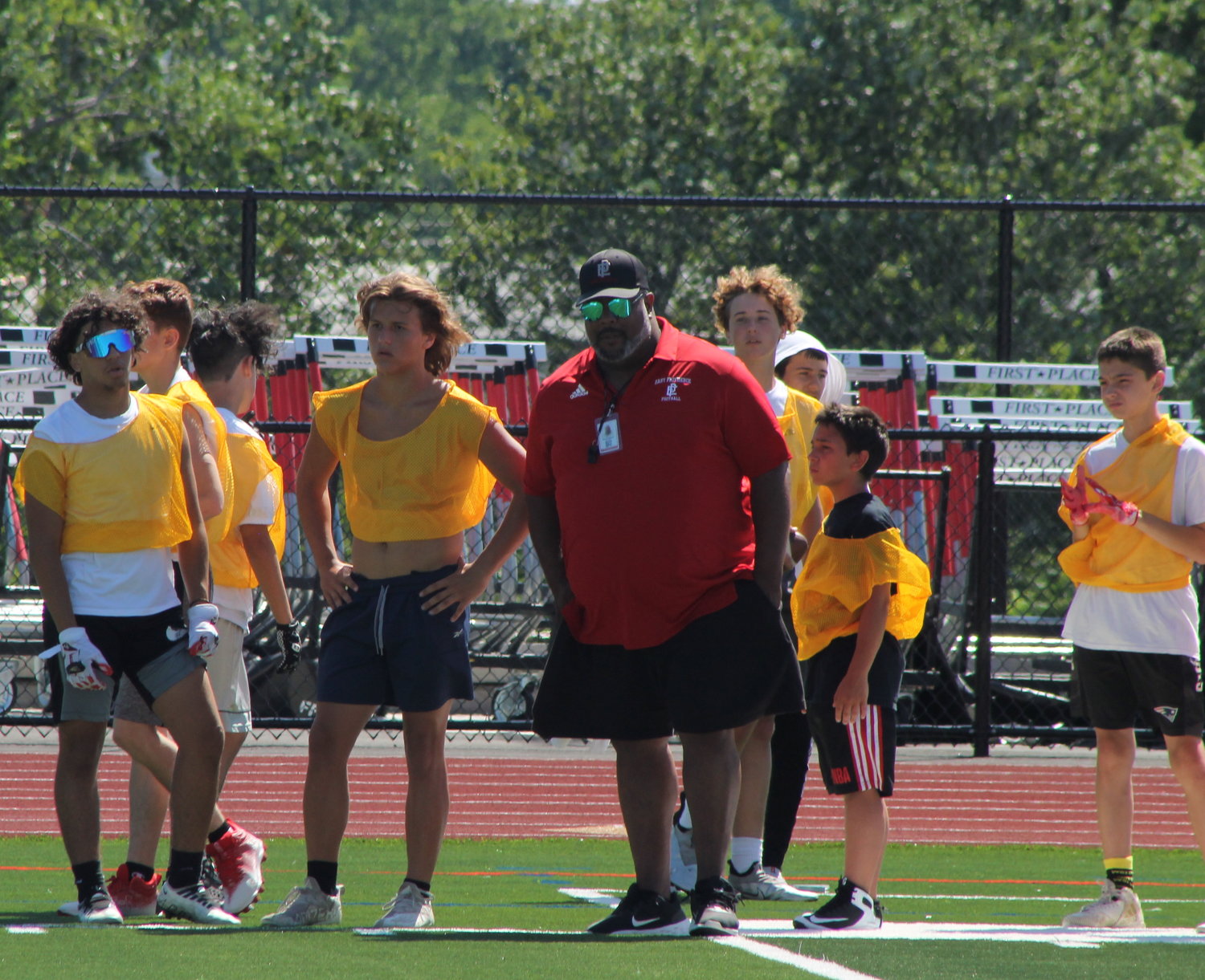 EPHS assistant coach Damian Ramos directs the Townies during their recent freshman/sophomore "7-on-7" passing tournament.
