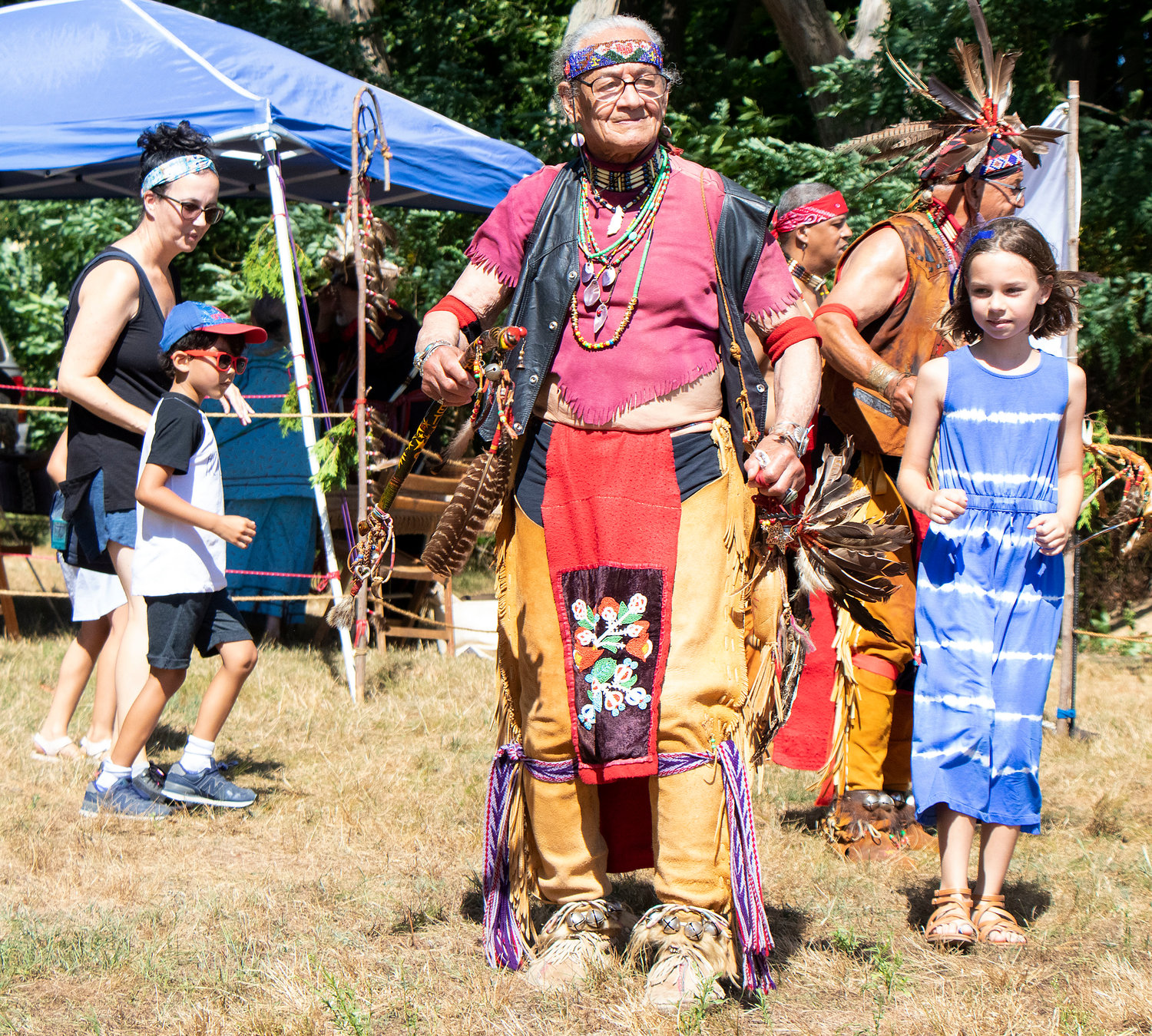 Lee Braveheart Edmonds (center) leads a Native American dance. 