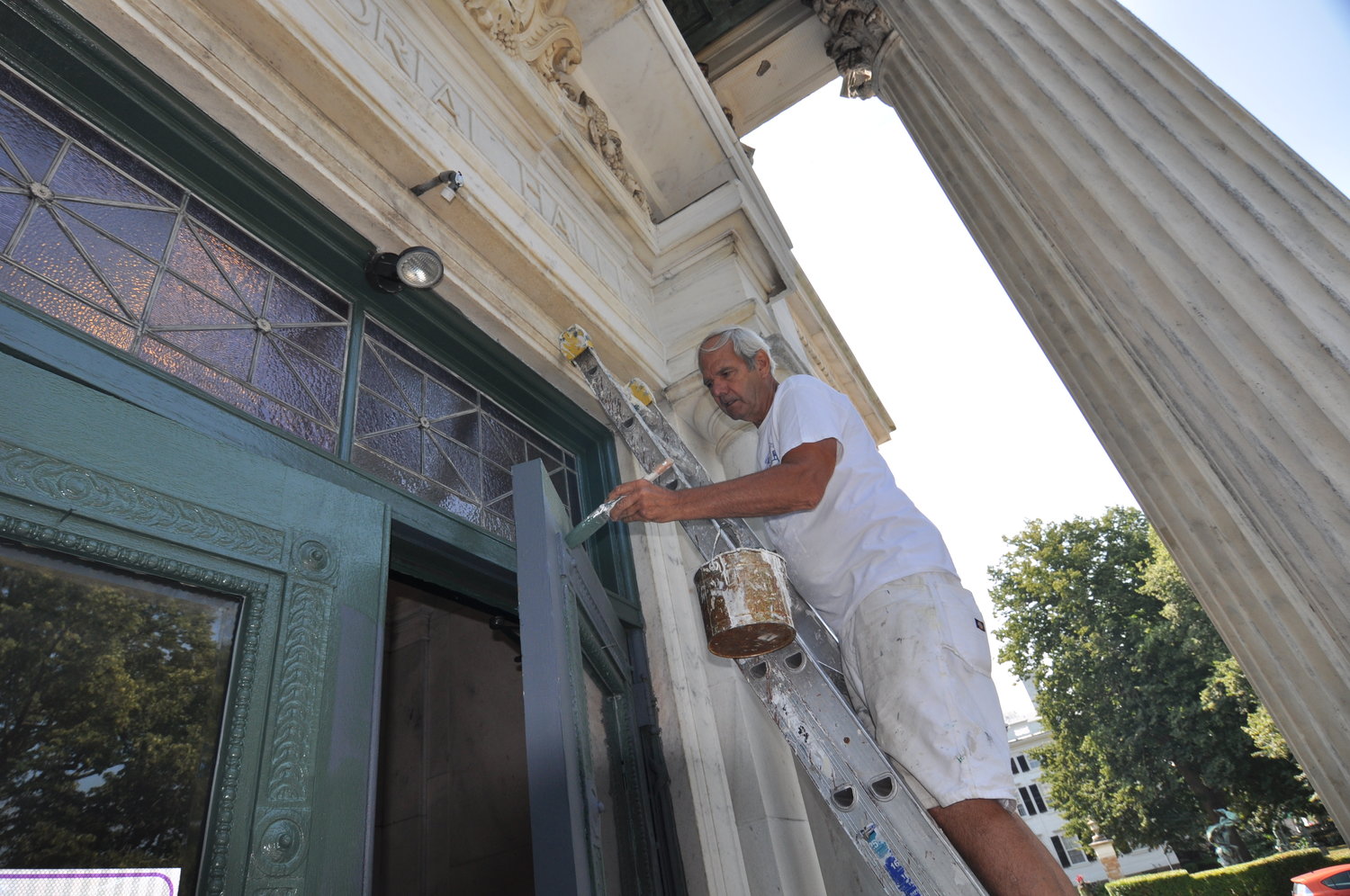 Former Colt Memorial High School basketball star Richard "Stick" Medeiros is always at the top his game, including painting the exterior of the school he once represented.