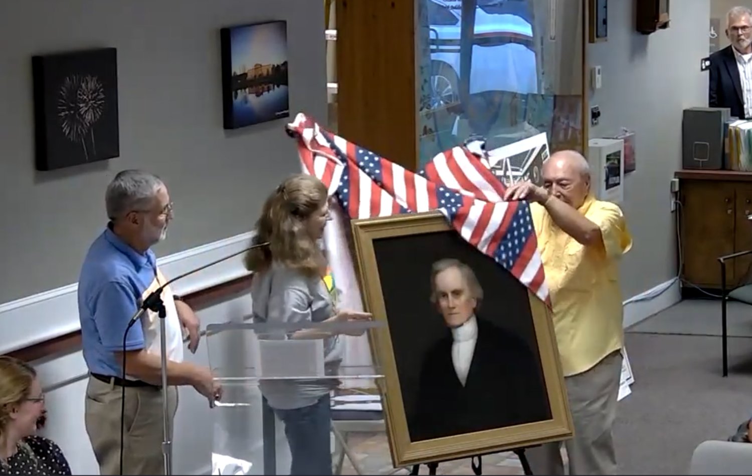 Revealing the restored Shepard portrait at the Wednesday, Aug. 2, Bristol Town Council meeting are (left to right) former Town Clerk Lou Cirillo, Charlotte Burnham, and former Superintendent of Schools Ennis Bisbano.