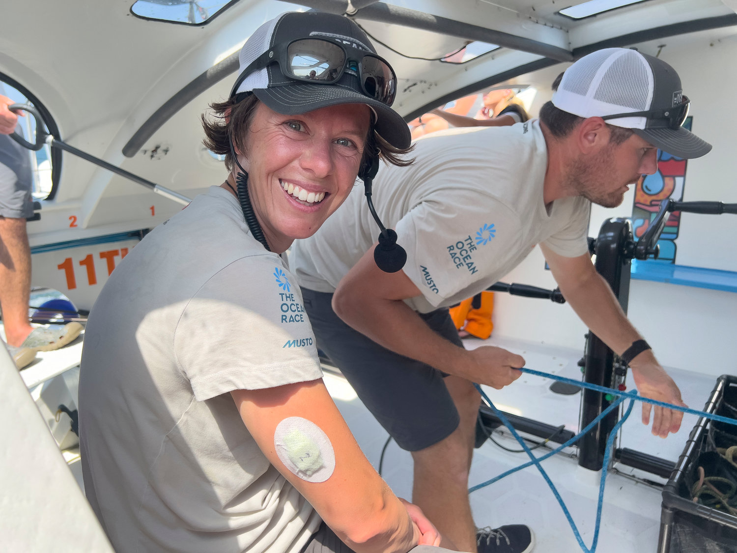 Italian sailor Francesca Clapcich, the team’s trimmer, shows off a patch on her arm to monitor sleeping while aboard the ship.