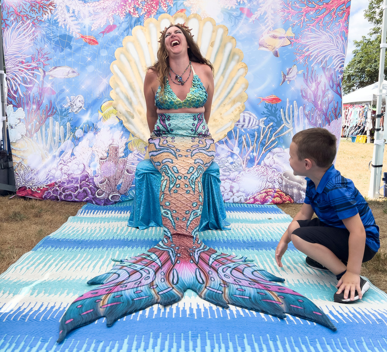 Jessie Jewels, “Ms. Mermaid Rhode Island 2021-22,” shares a laugh with Ryatt Bonalewicz at her tent.