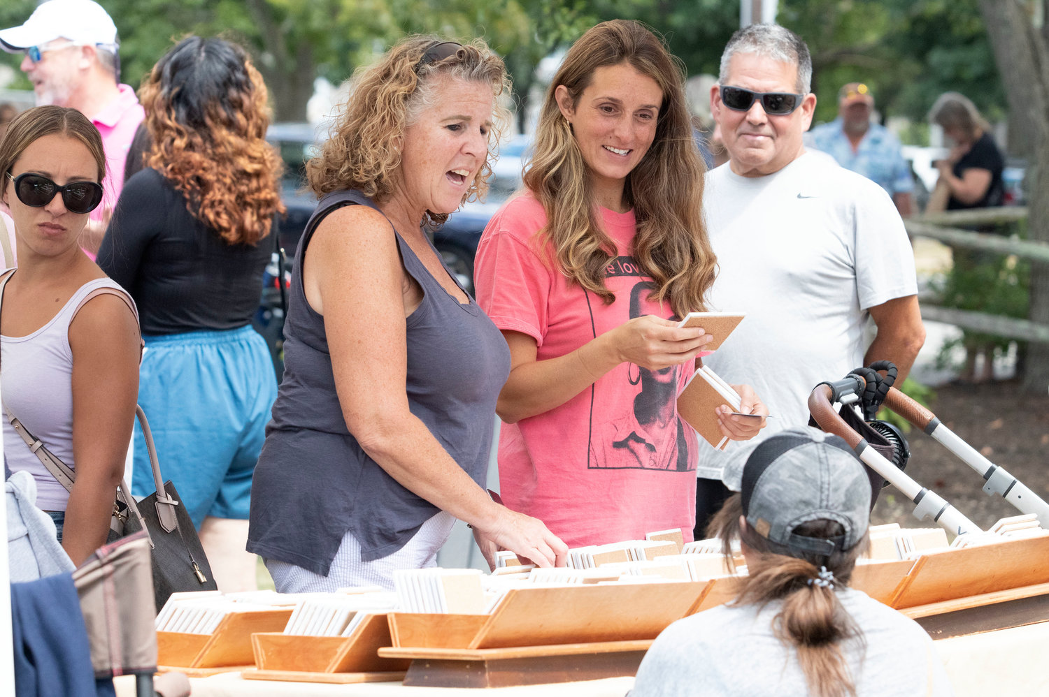 Pam Sheerin (left) and Jillian Amaral check out hand made coasters by Christine Jannerelli at the 2022 "The Looff" East Providence Arts Fest Saturday, Aug. 13.