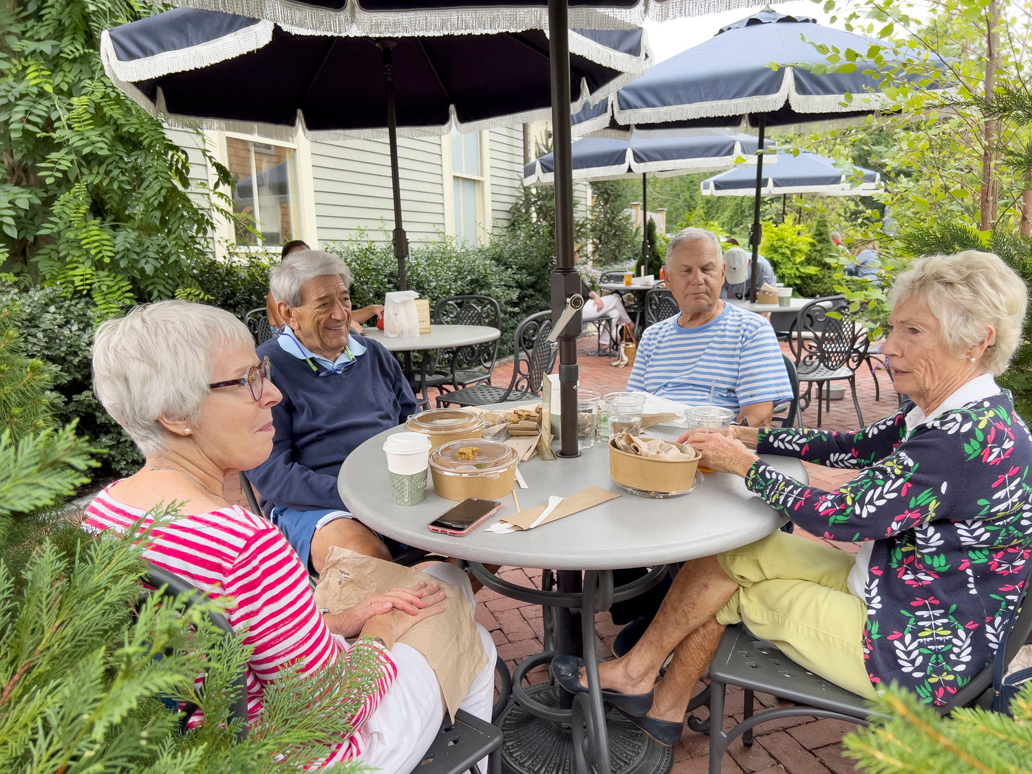 Sandra Freedman(left), Ed Regan, Alex Freedman and Sydney Regan chat during lunch at a new outdoor table at Groundswell.