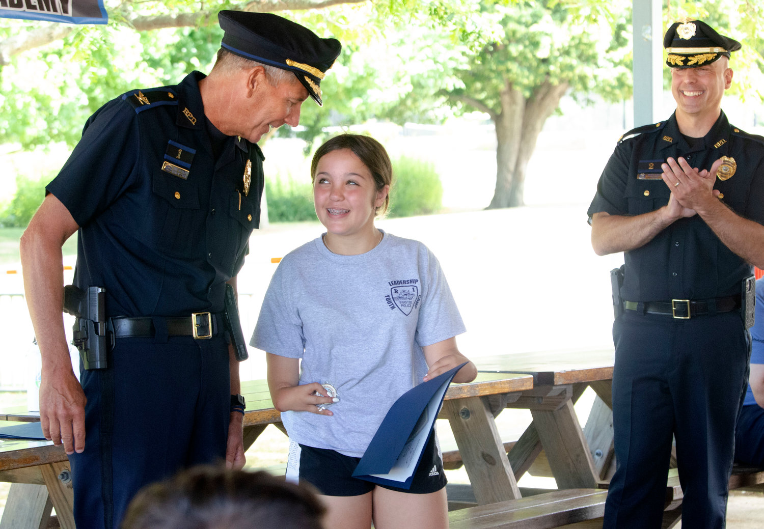 Ella Pirri accepts a certificate of appreciation from Bristol Police Chief Kevin Lynch (left) and Major Brian Burke.