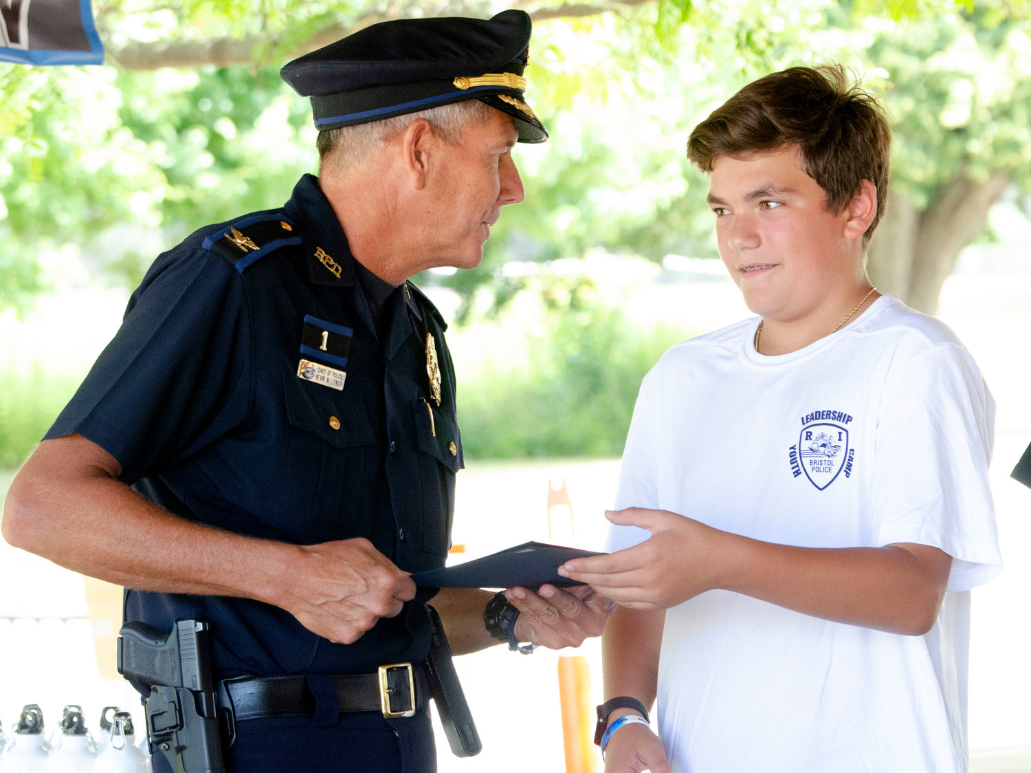 Bristol Police Chief Kevin Lynch poses with Domenic Baldinelli after she received a certificate of appreciation during the Bristol Police Youth Leadership Academy at the town beach on Friday.