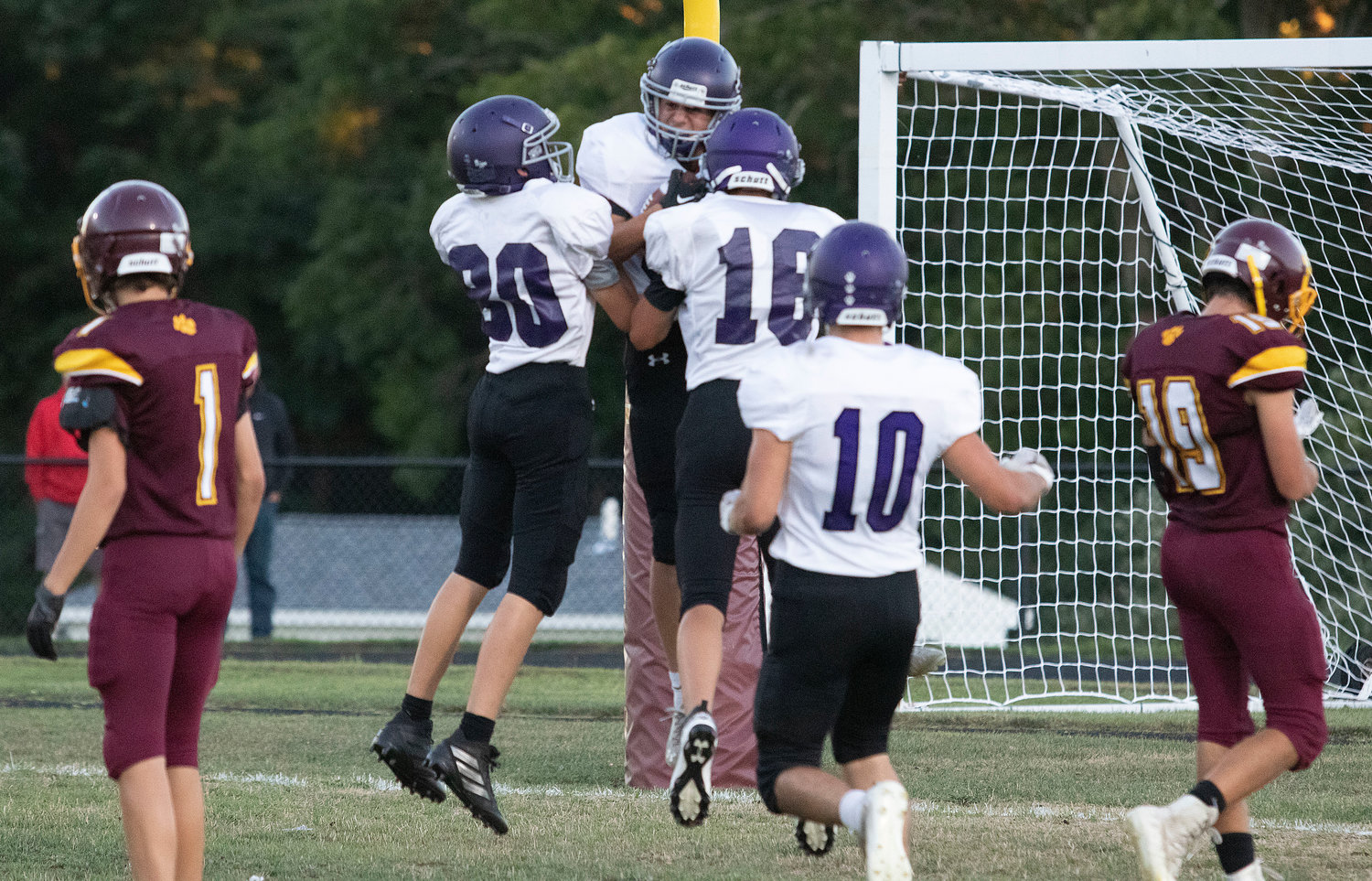 Huskies celebrate with Evan Rodrigues (middle) after he scored on a 30-yard touchdown run.