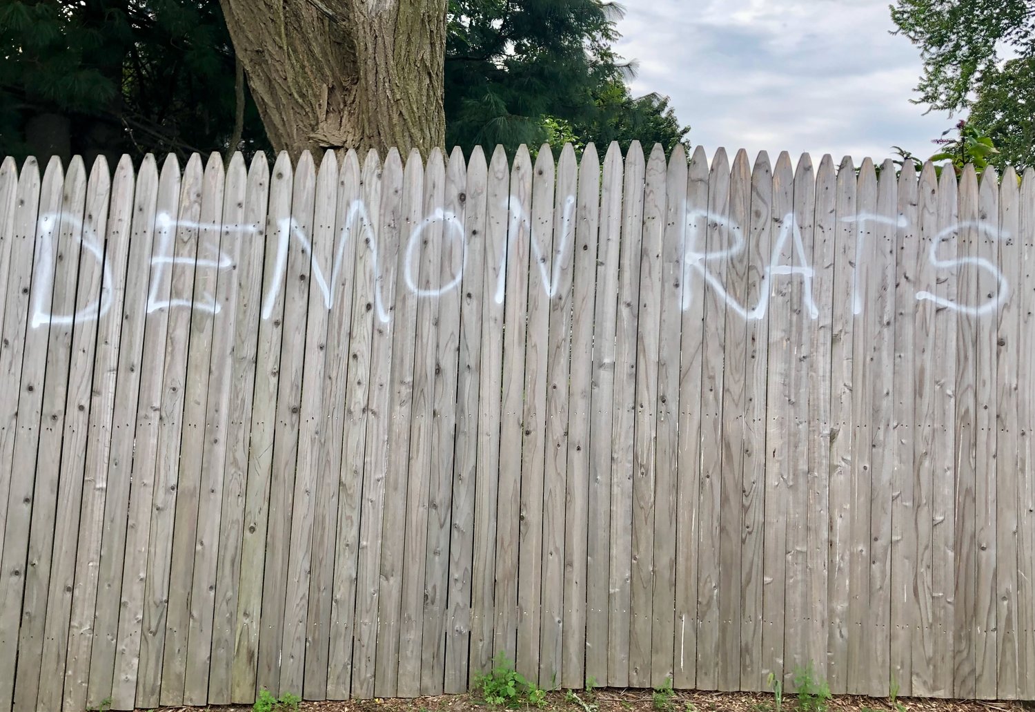An example of the graffiti that appeared on a fence outside the CFP Arts, Wellness, and Community Center on Sunday, just hours before the Portsmouth Democratic Town Committee’s annual fund-raiser there.