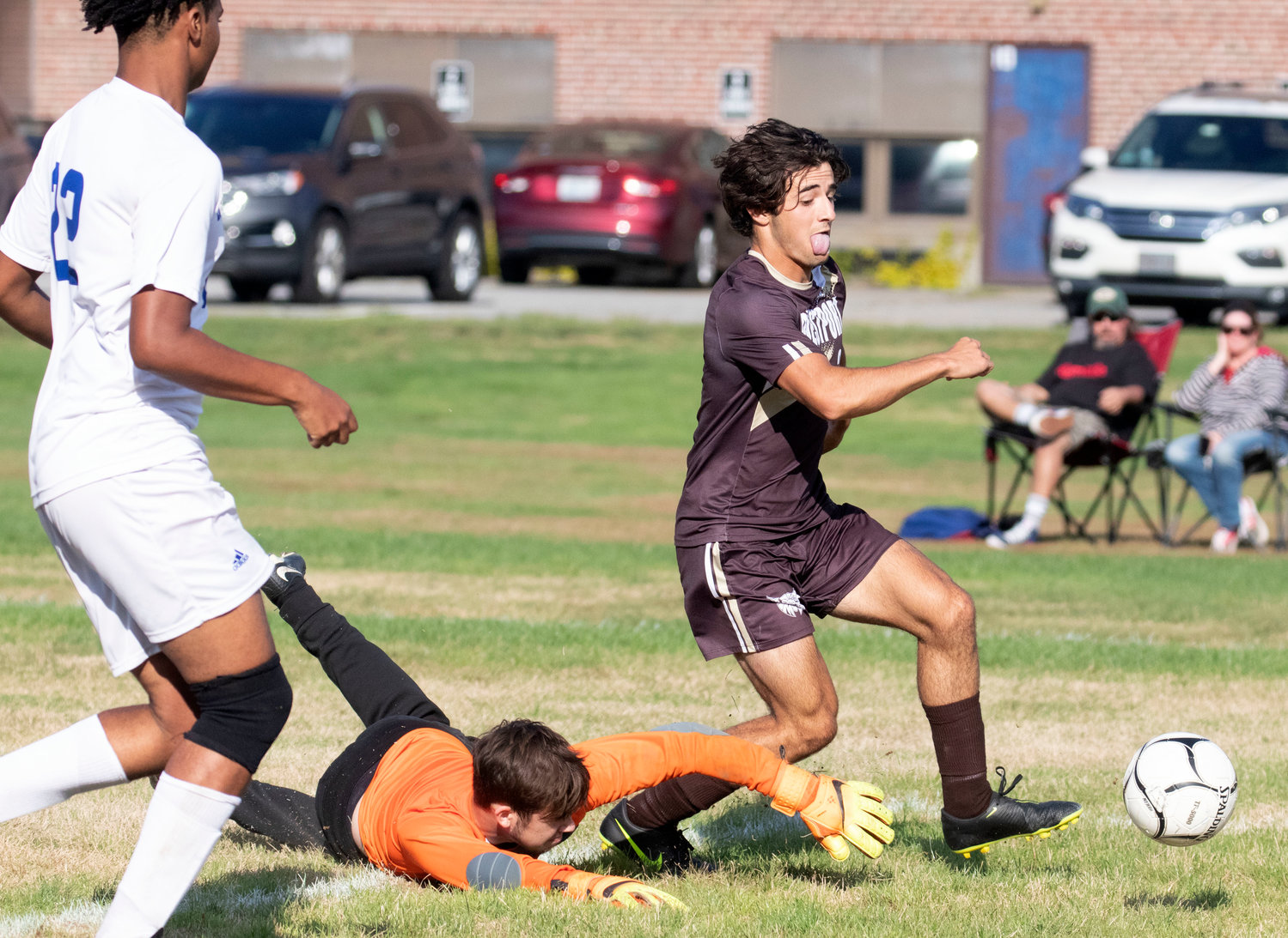 Hunter Brodeur dribbles around goalkeeper Caden Brasill and makes a pass to a teammate during the game.