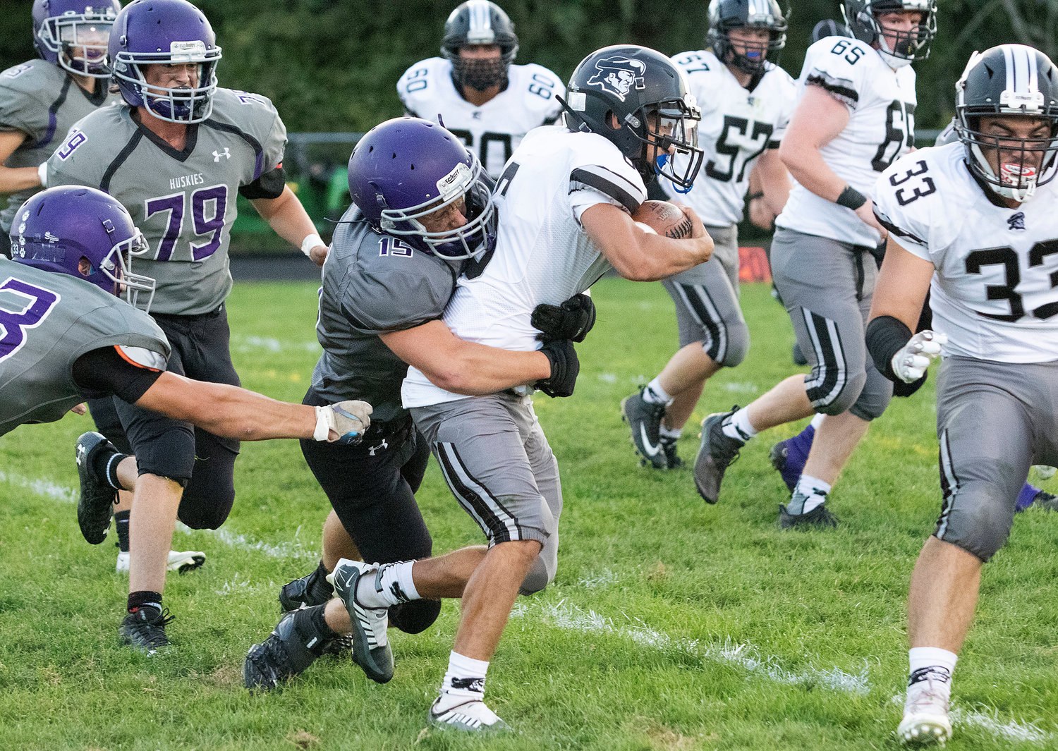 Middle linebacker James Thibaudeau makes one of his team high twelve tackles during the game.