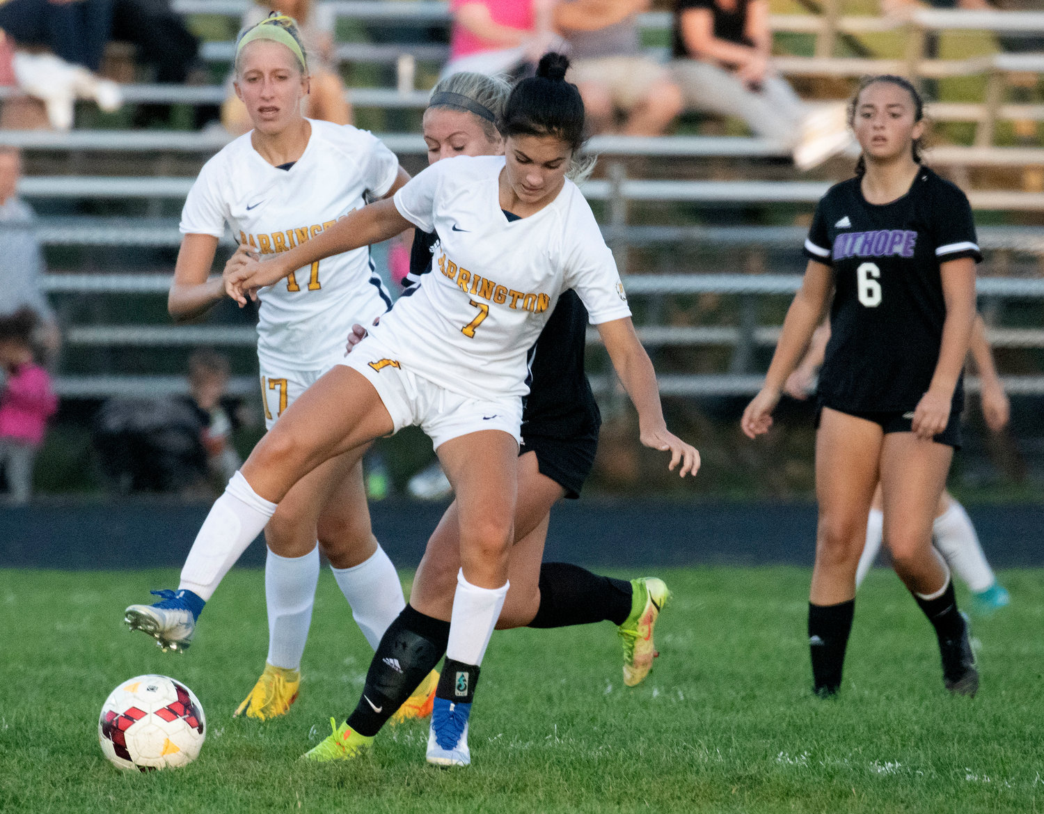 Lily Swintak (left) looks on as teammate Hannah Carlotto takes the ball away from a Huskies forward.