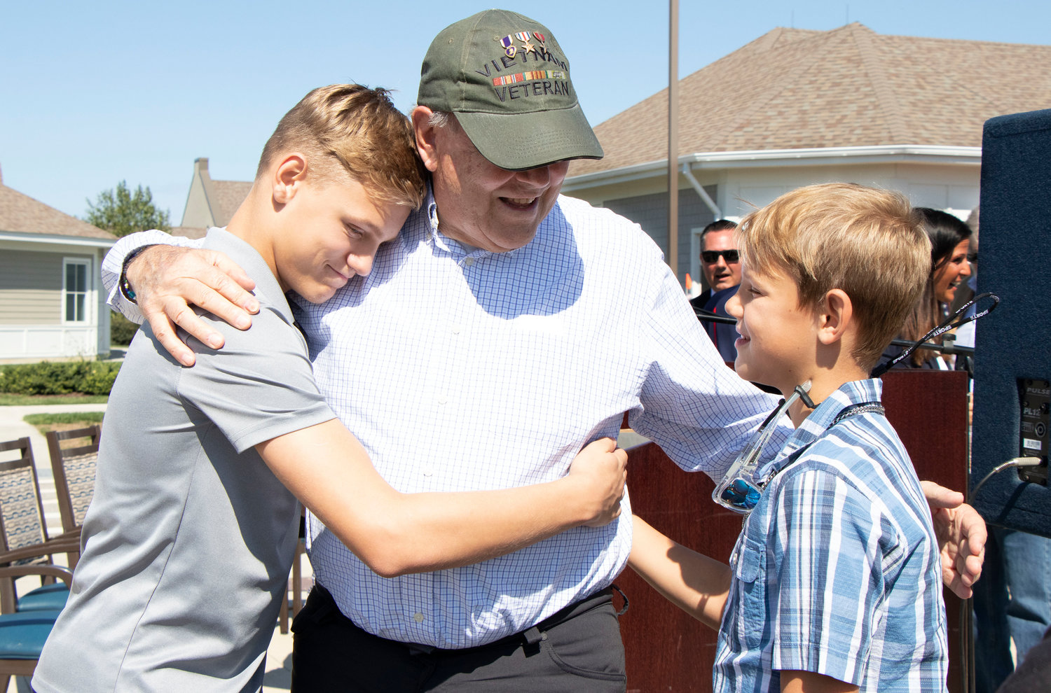 Ty ward 13, (left) and brother Chase Ward, 11, give grandfather and Vietnam War veteran Robert Ward a hug after the ceremony. Mr. Ward was honored during the event as he has two purple hearts and a bronze and silver star from his time in Vietnam.