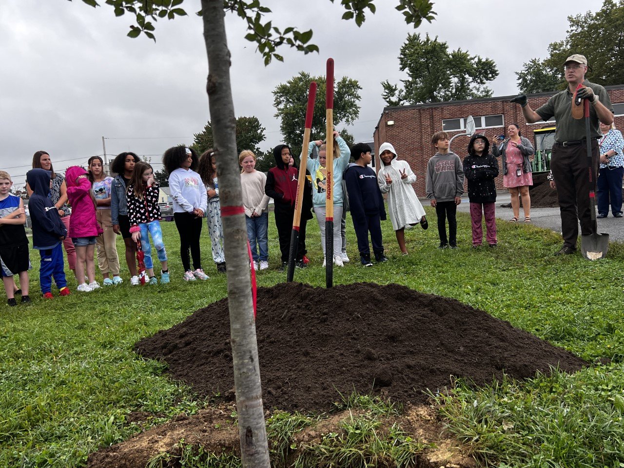 Doug Still, principal of the local company This Old Tree Consulting, explains to Orlo Avenue fourth graders about the importance of trees to the environment during a planting event at the school September 21.