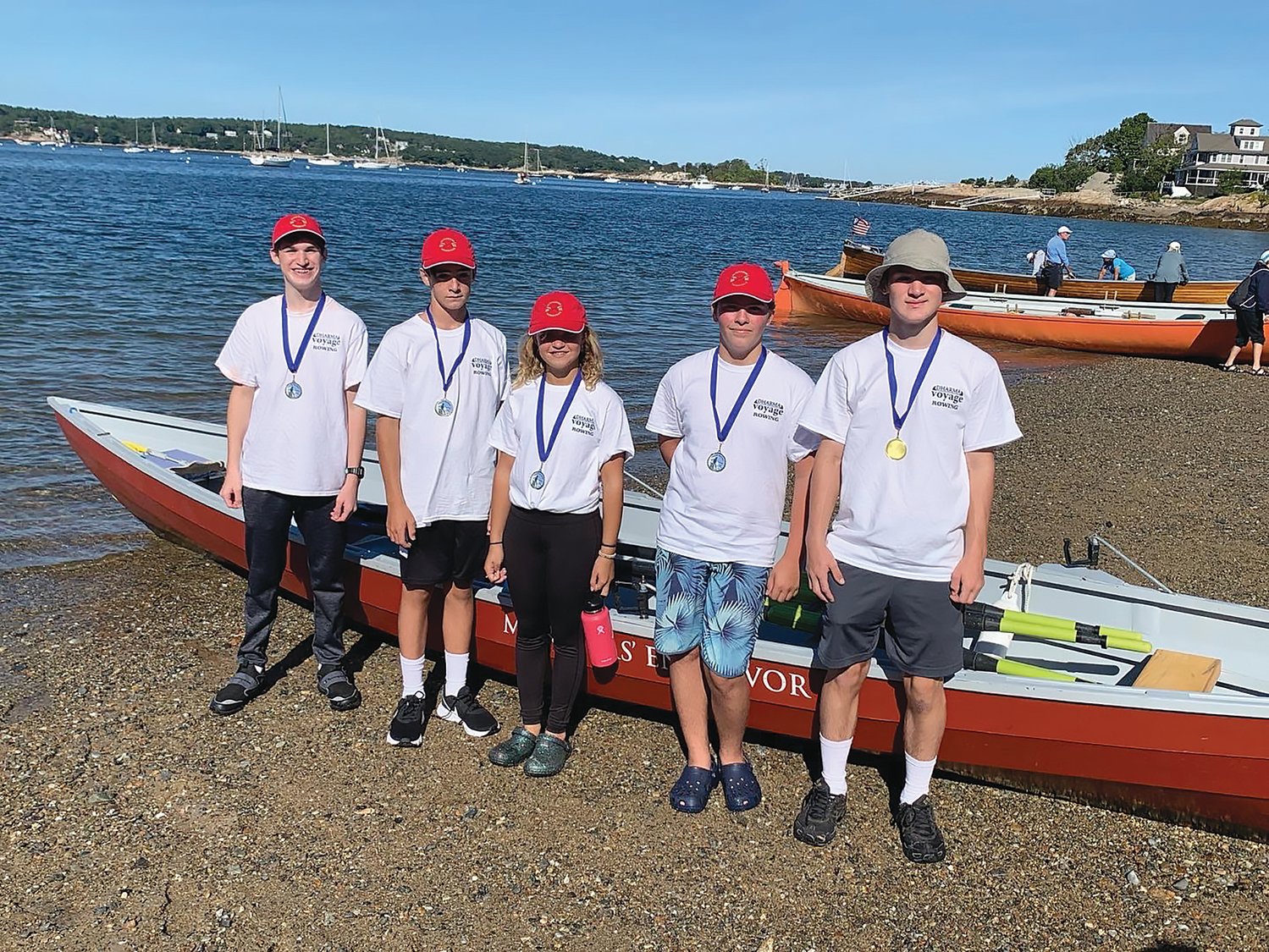 From left, Ethan Stewart, 11 (coxswain), Sam Hall, 13 (stroke), Aja Crockett, 11, Ryder Jusseaume, 14, and Blake Stewart, 13, pose for a photo during Saturday's competition on Gloucester Harbor.