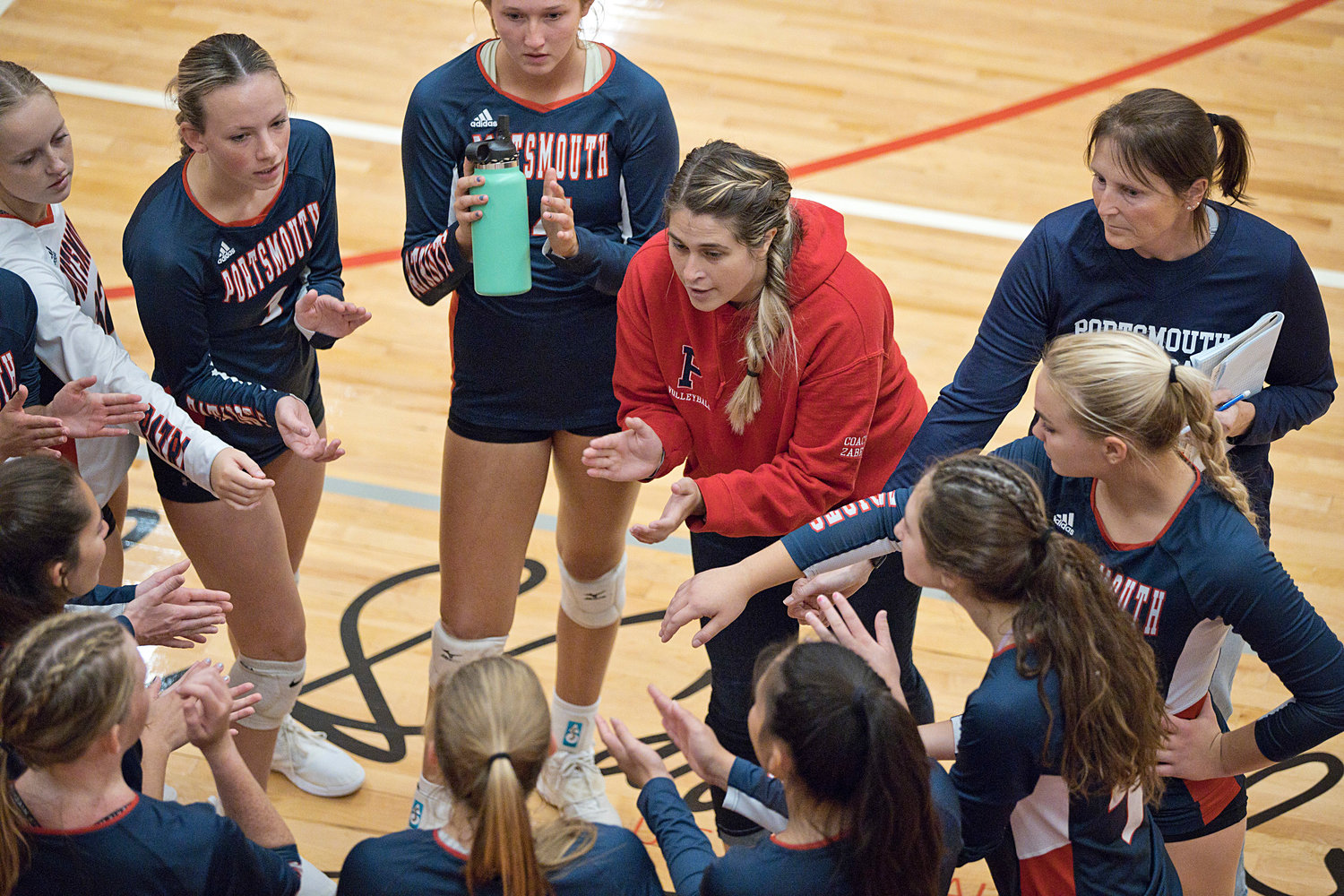 Head coach Lisa Zabel encourages her team between sets during Friday's match against East Providence.