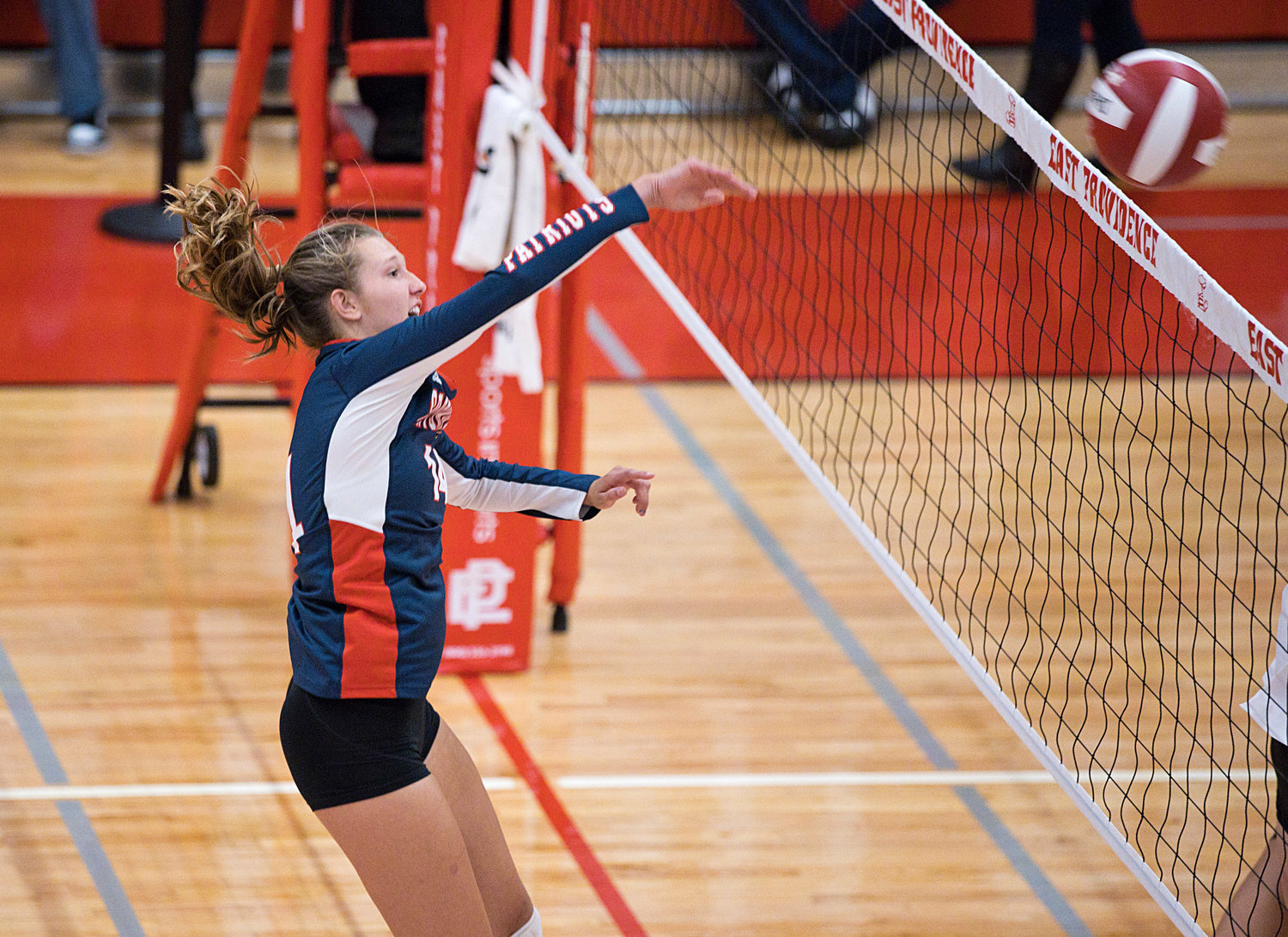 Morgan Casey fires a hard spike over the net while battling East Providence.