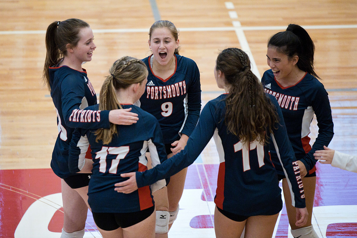 The Patriots celebrate a point during a close set against East Providence.