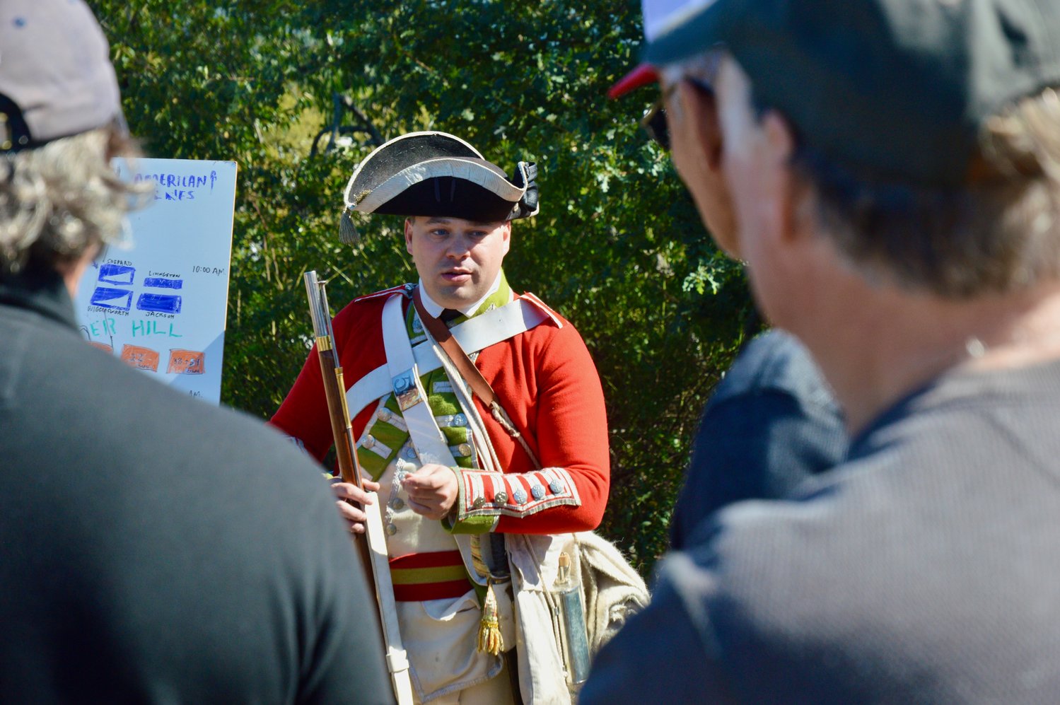 Seth Chiaro of Portsmouth, a member of the 54th Regiment of Foot, speaks with visitors to Heritage Park. Chiaro is involved in efforts to restore Butts Hill Fort, located further north.