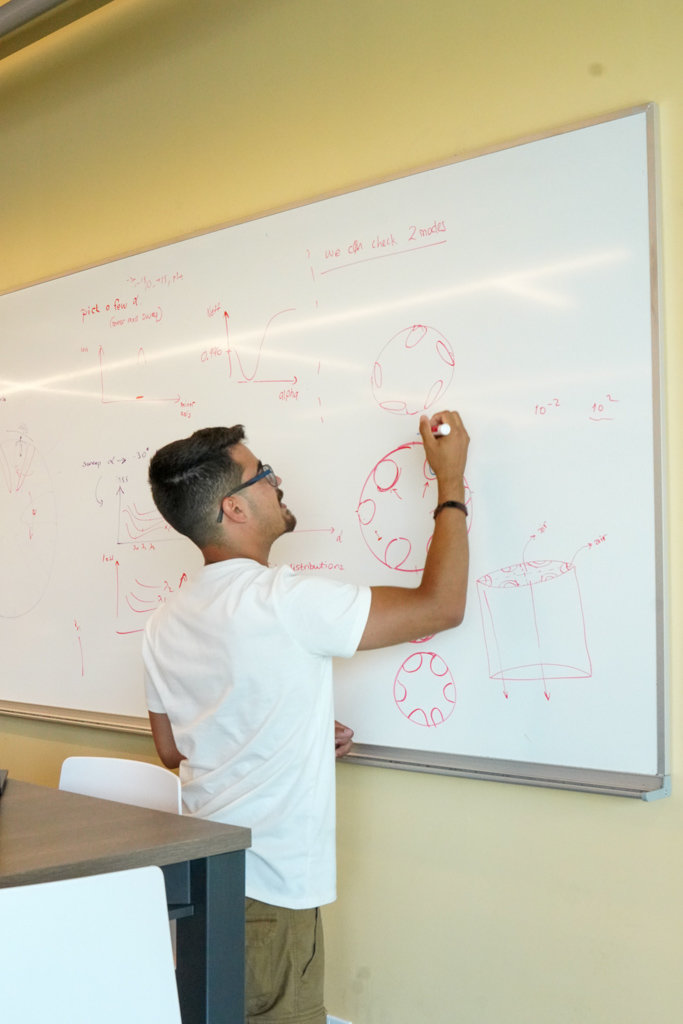 As part of his lasers-related research, ​Armas draws models on a whiteboard in SECCM Labs.