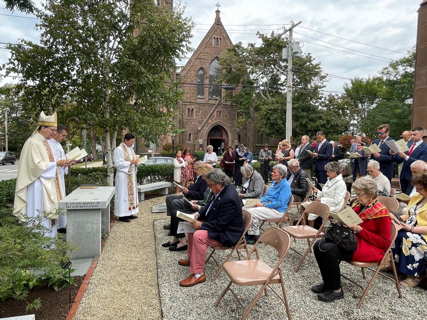 St. Michael’s parishioners gathered for the rededication of their redesigned Memorial Garden. Presiding over the service was Right Revd. Nicholas Knisely, Bishop of the Episcopal Diocese of Rhode Island; the Revd. Deacon James Kelliher, the Bishop’s Chaplain; and the Revd. Canon Michael J. Horvath, Rector of St. Michael’s.