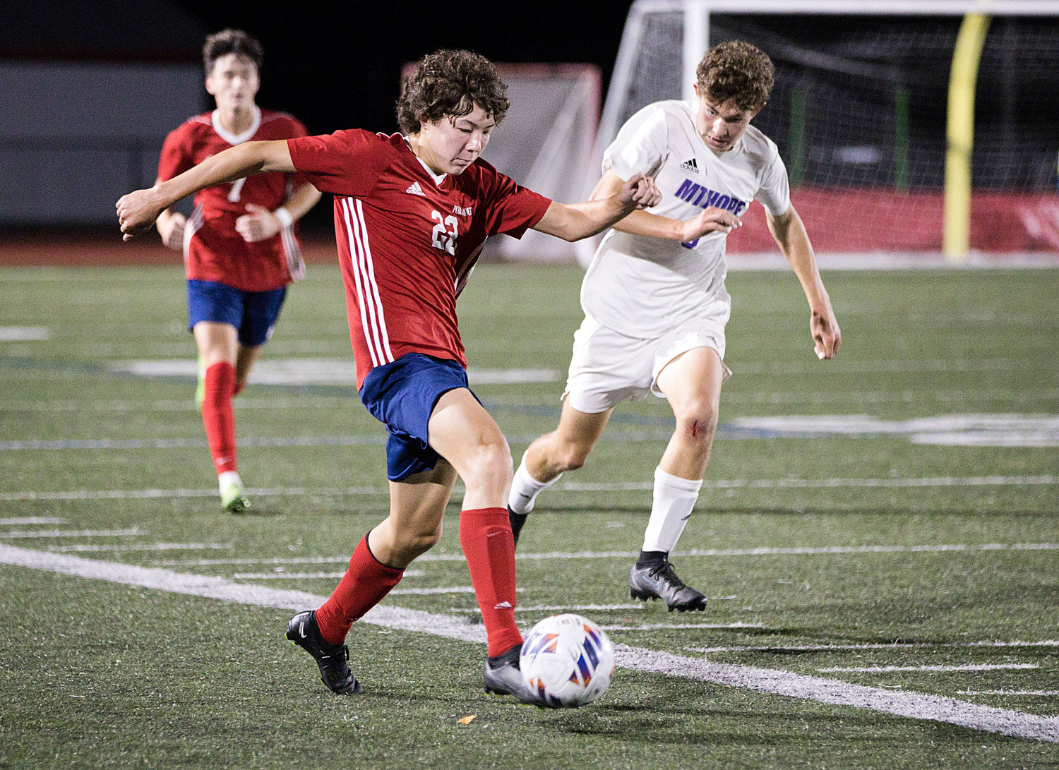 Aidan Chen races the ball past Mt. Hope opponents.