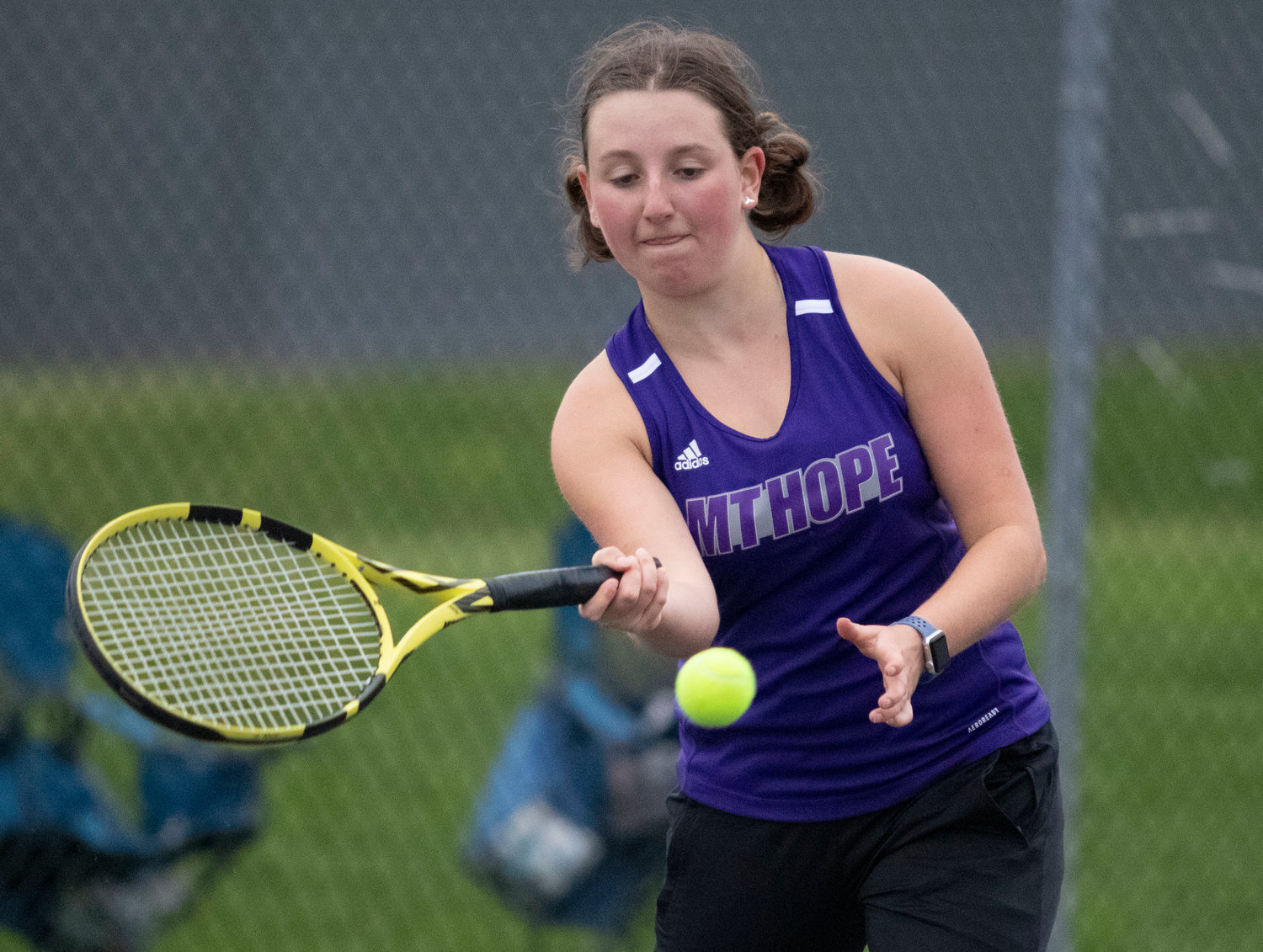 Junior captain Cate Merriam hits a forehand during her match against Katie Byon of Barrington.