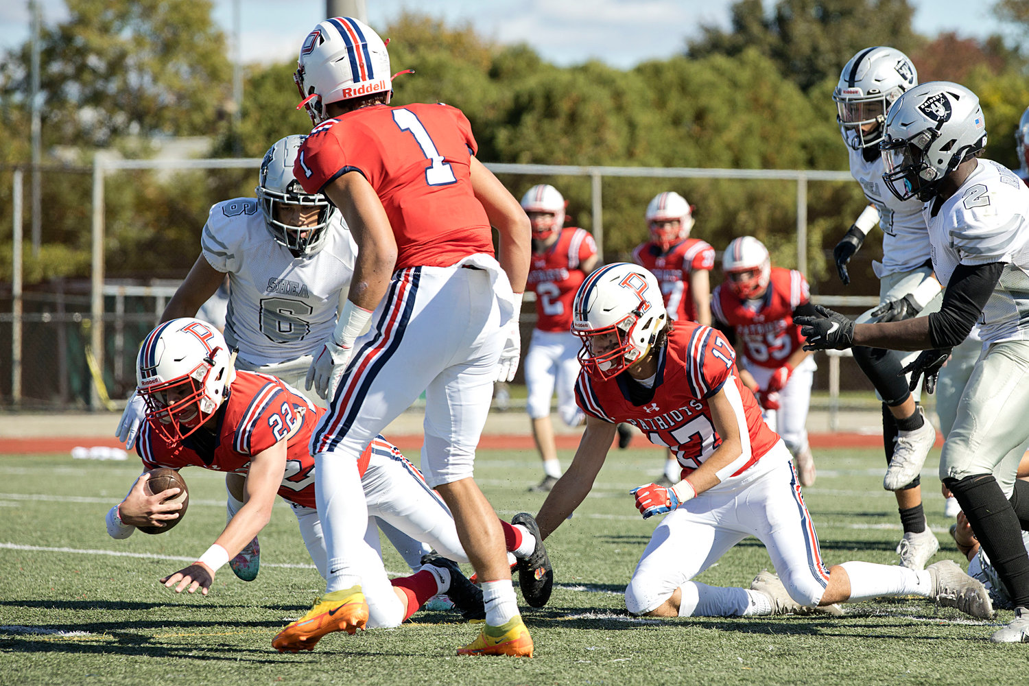 Dylan Brandariz dives through the Shea defense to advance the ball for the Patriots.