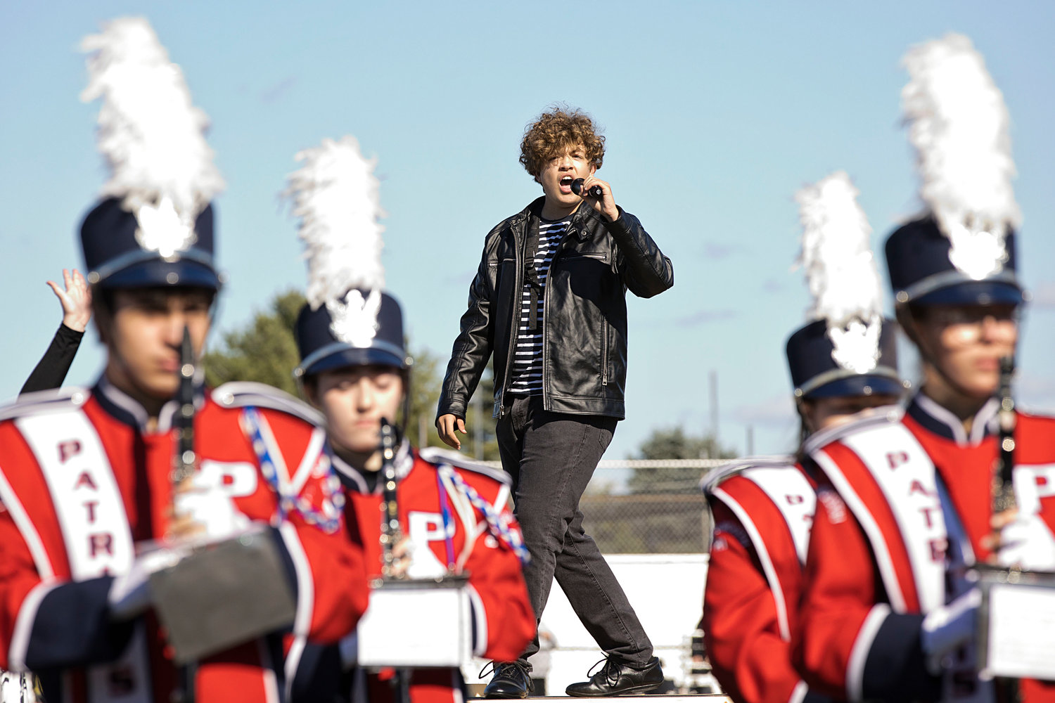 Sophomore Dillion Fesmire plays the king of rock and roll while singing along to the band during halftime of the game, won by the Patriots, 14-7.