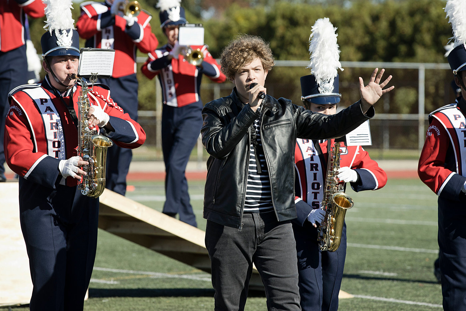 Sophomore Dillion Fesmire waves to the crowd after performing as “Elvis” with the Portsmouth High School Marching Band on Saturday.