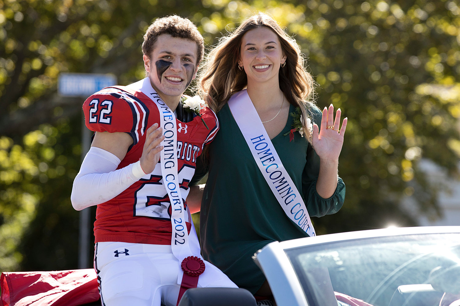 Dylan Brandariz and Ava Hackley, members of the Homecoming Court, wave to the crowd.