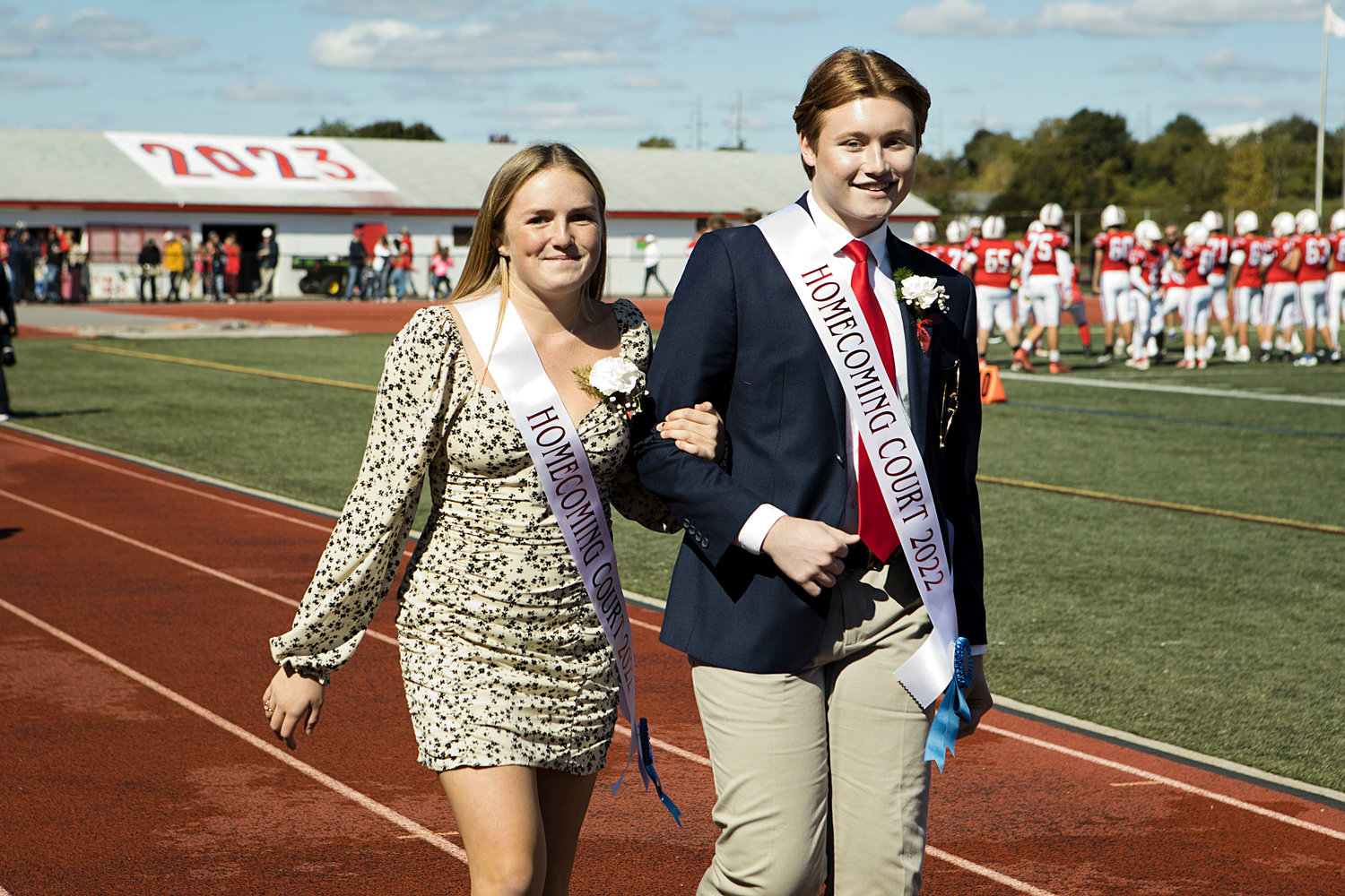 Jack Hollen escorts Elise Kirwin to the PHS turf field after the parade.