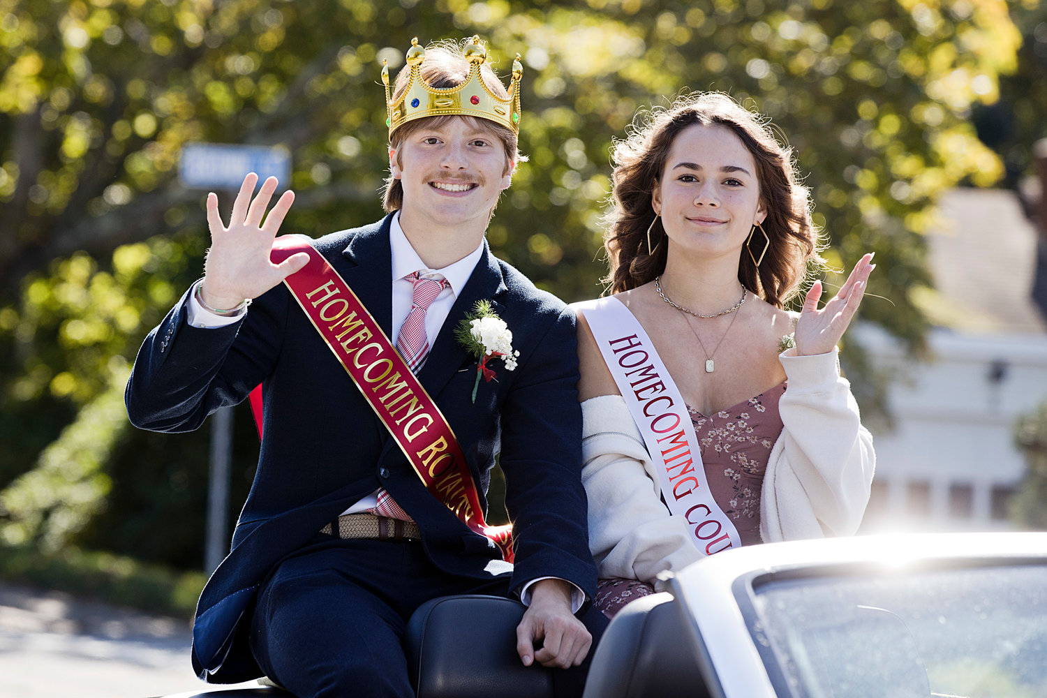 Homecoming King Nick Waycuilis (Luke Carlin was the other king) and Morgan Levreault, wave to spectators while riding through Portsmouth’s Homecoming parade on Saturday.