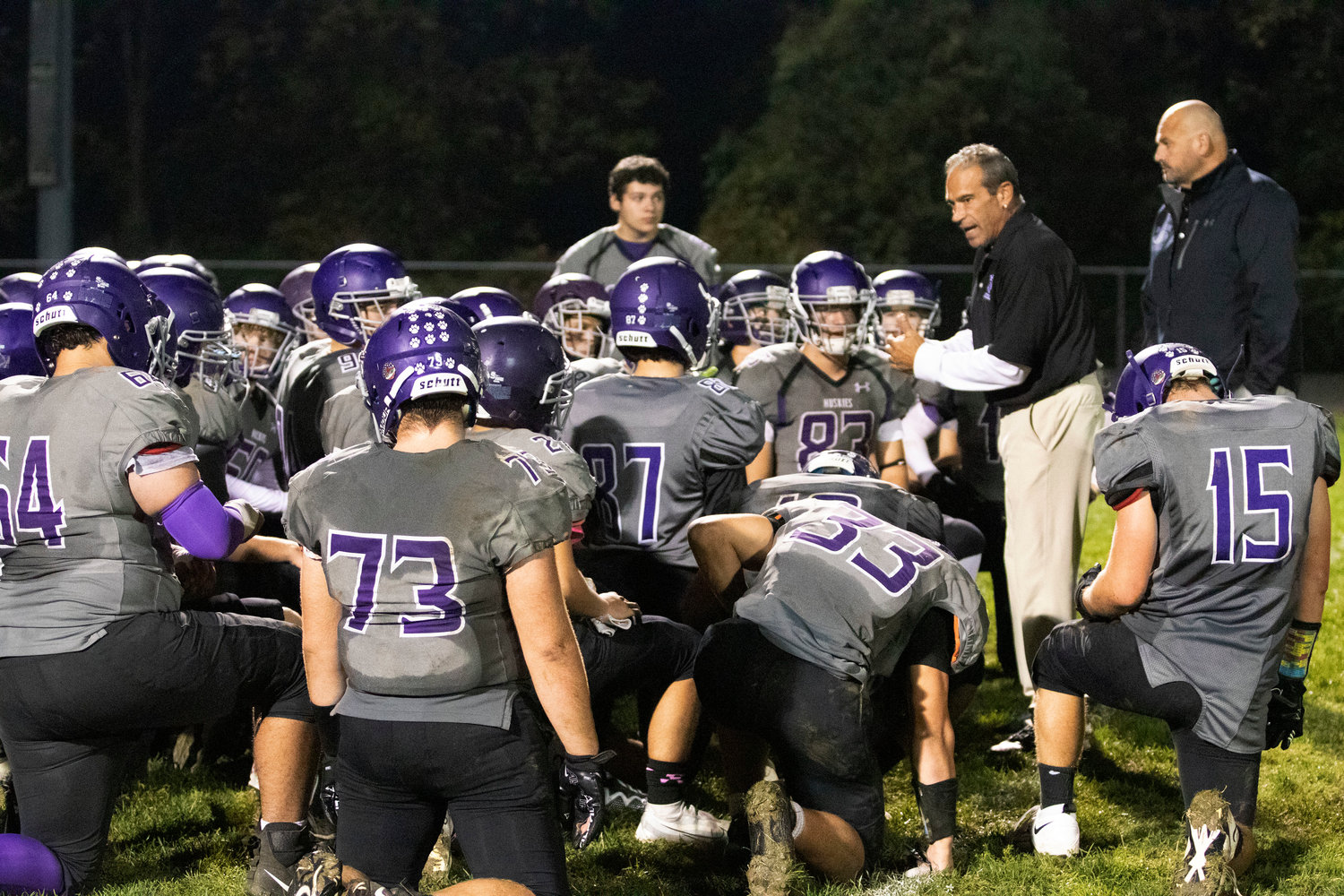 Huskies head coach Thomas DelSanto Jr. (right) speaks to the his young team after the loss.