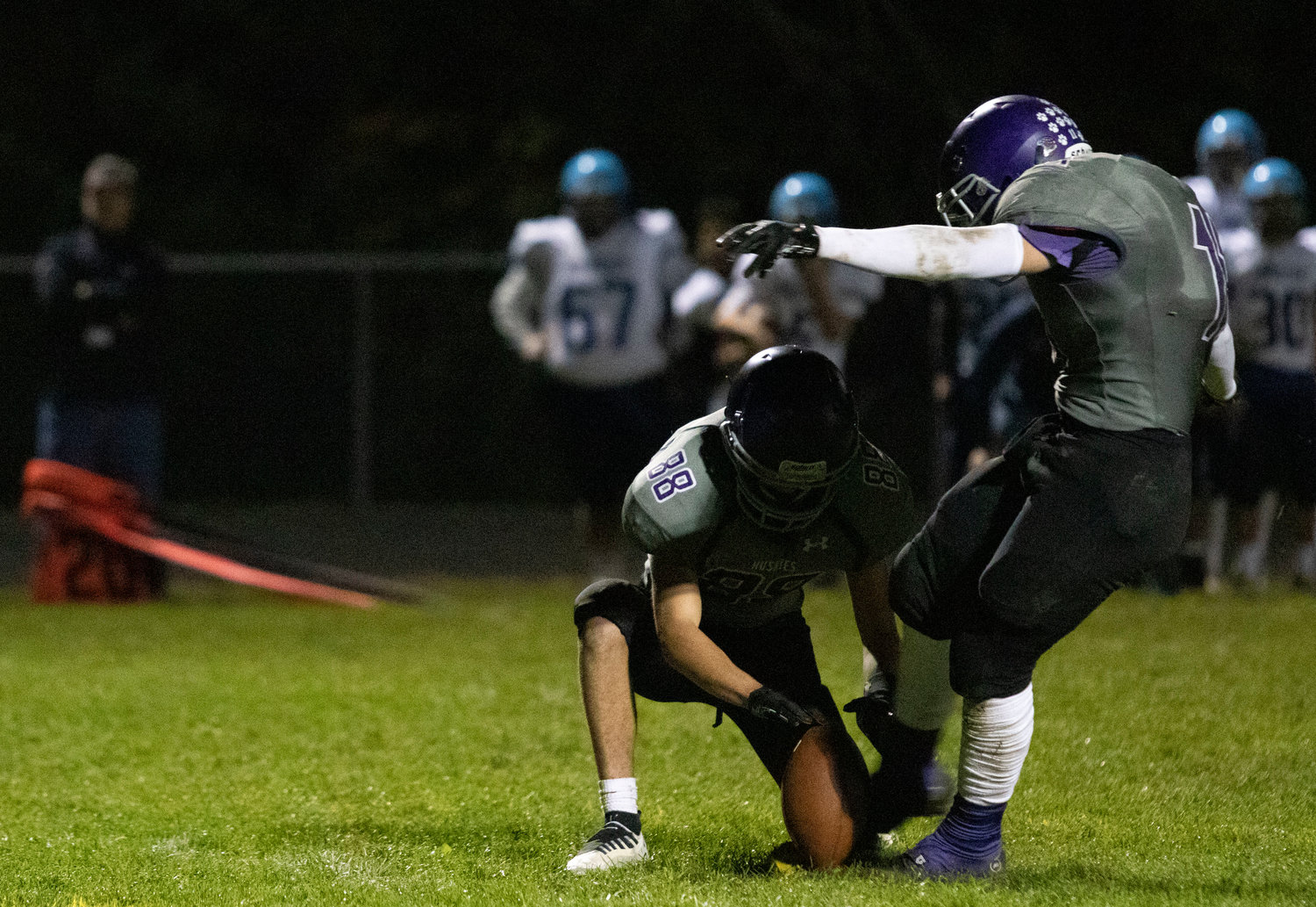 Sophomore place kicker Jerry Pimental attempts to kick an extra point in the fourth quarter. But the Panthers burst through and blocked the kick.