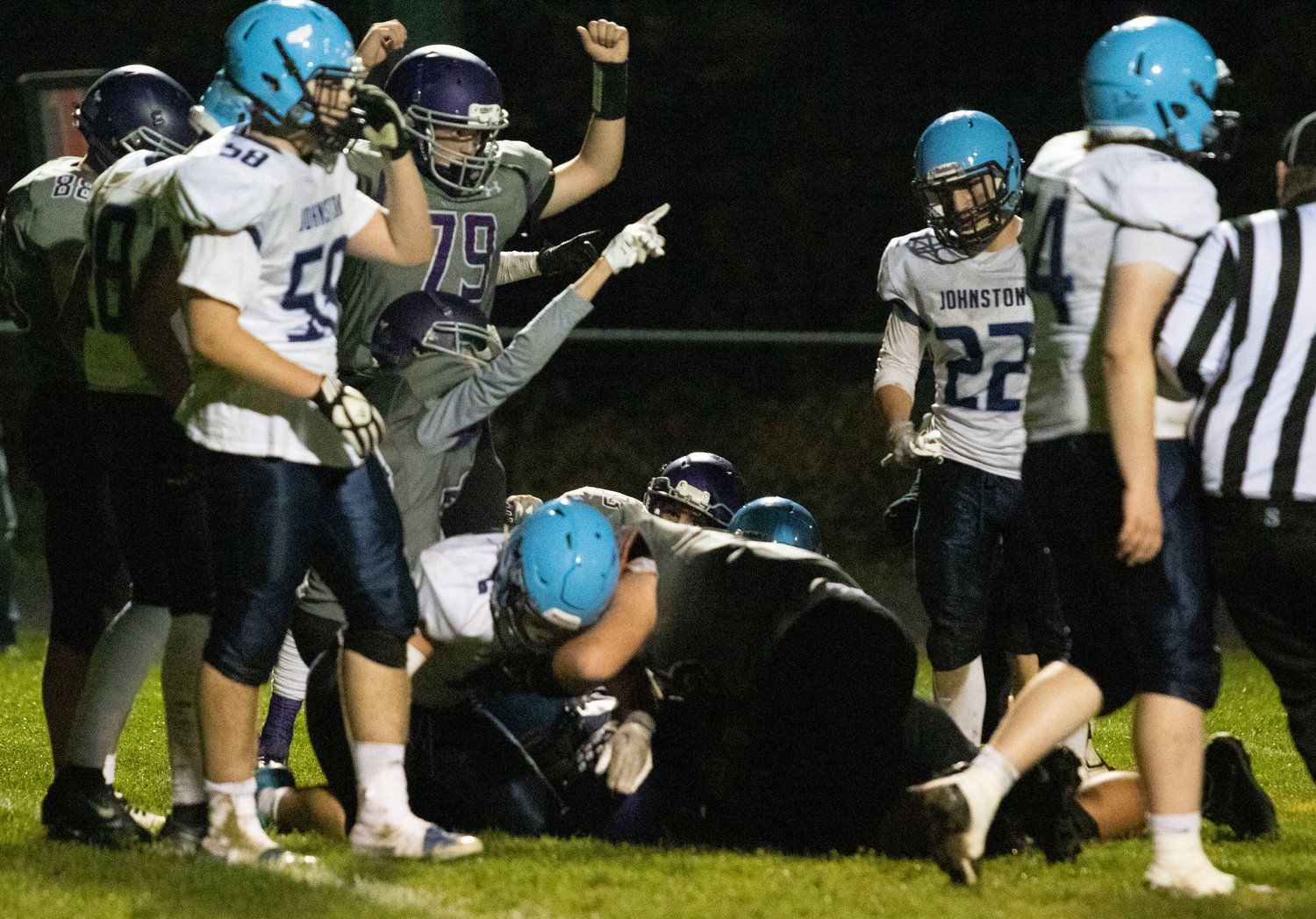 Huskies signal a fumble recovery by cornerback Ethan Martel as Johnston fumbled a snap in the third quarter.