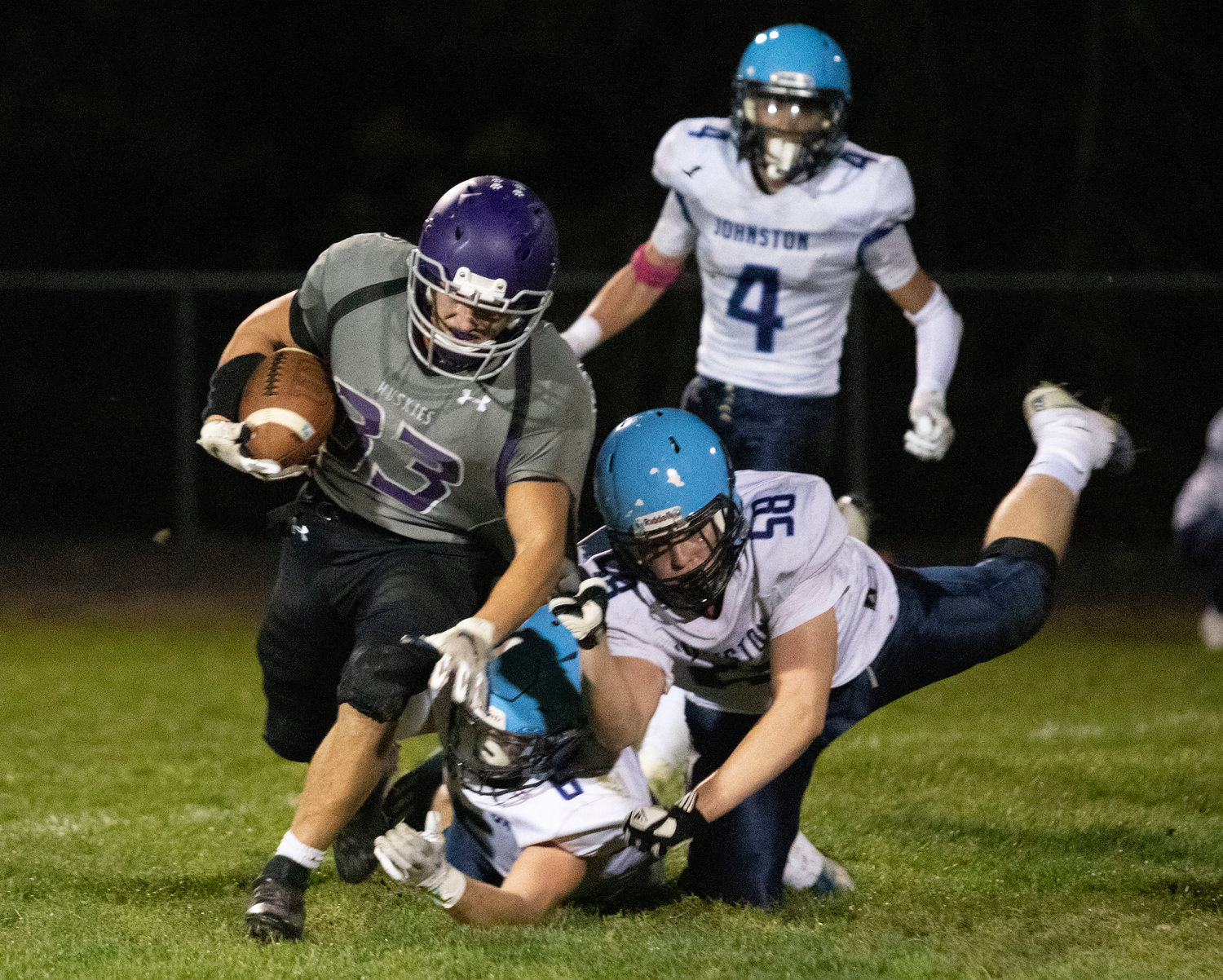 Senior running back Brock Pacheco runs for yardage during their loss to Johnston. Pacheco rushed for 110 yards and a touchdown in the Huskies loss to Ponaganset on Friday night. The running back has gained 850 yards for the season and has two games left to break the 1000 yard mark.