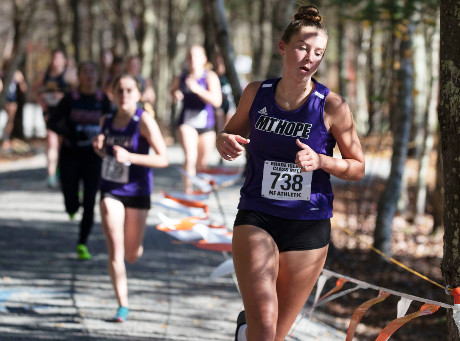 Senior Reyn Ferris runs through the wooded part of the course. She placed 28th with a time of 22:25.2.