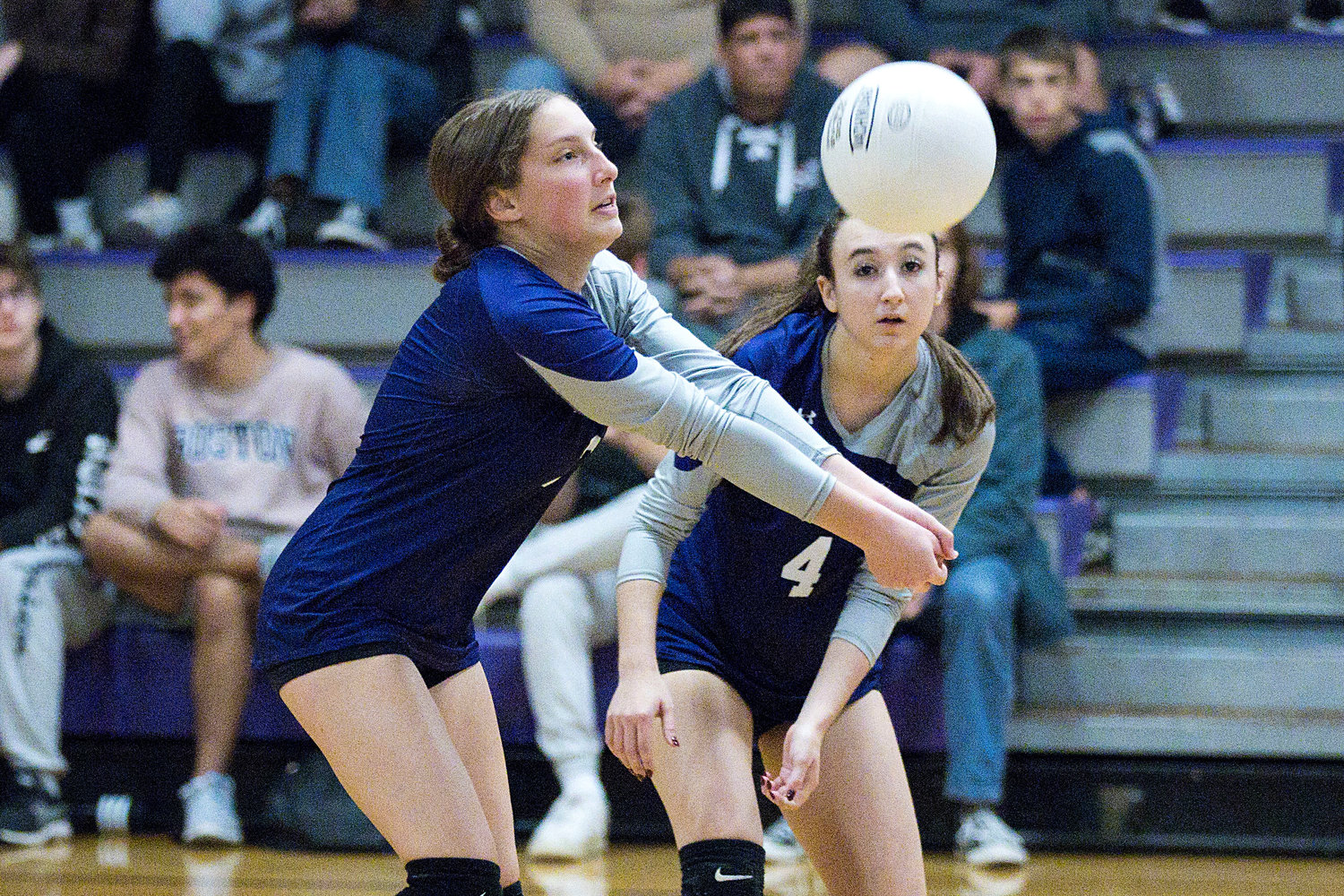 Gwenyth Tucker looks on as Emma Torres bumps the ball up for a teammate. 