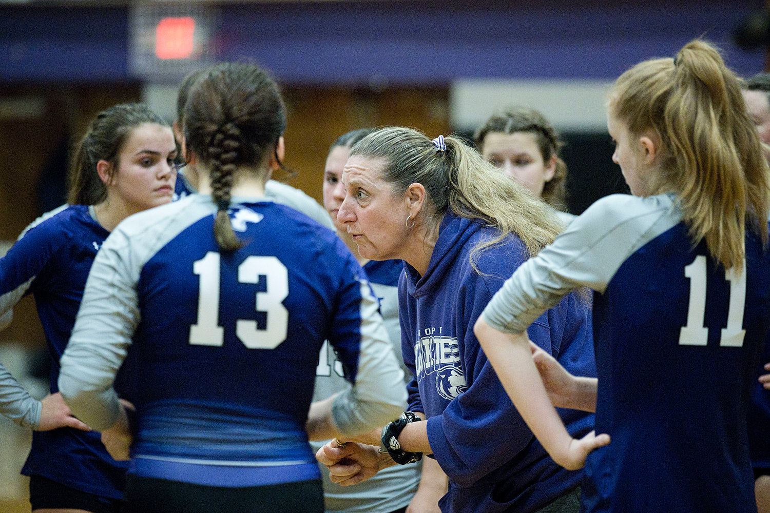Head Coach Lisa Lunney talks with her team between sets. 