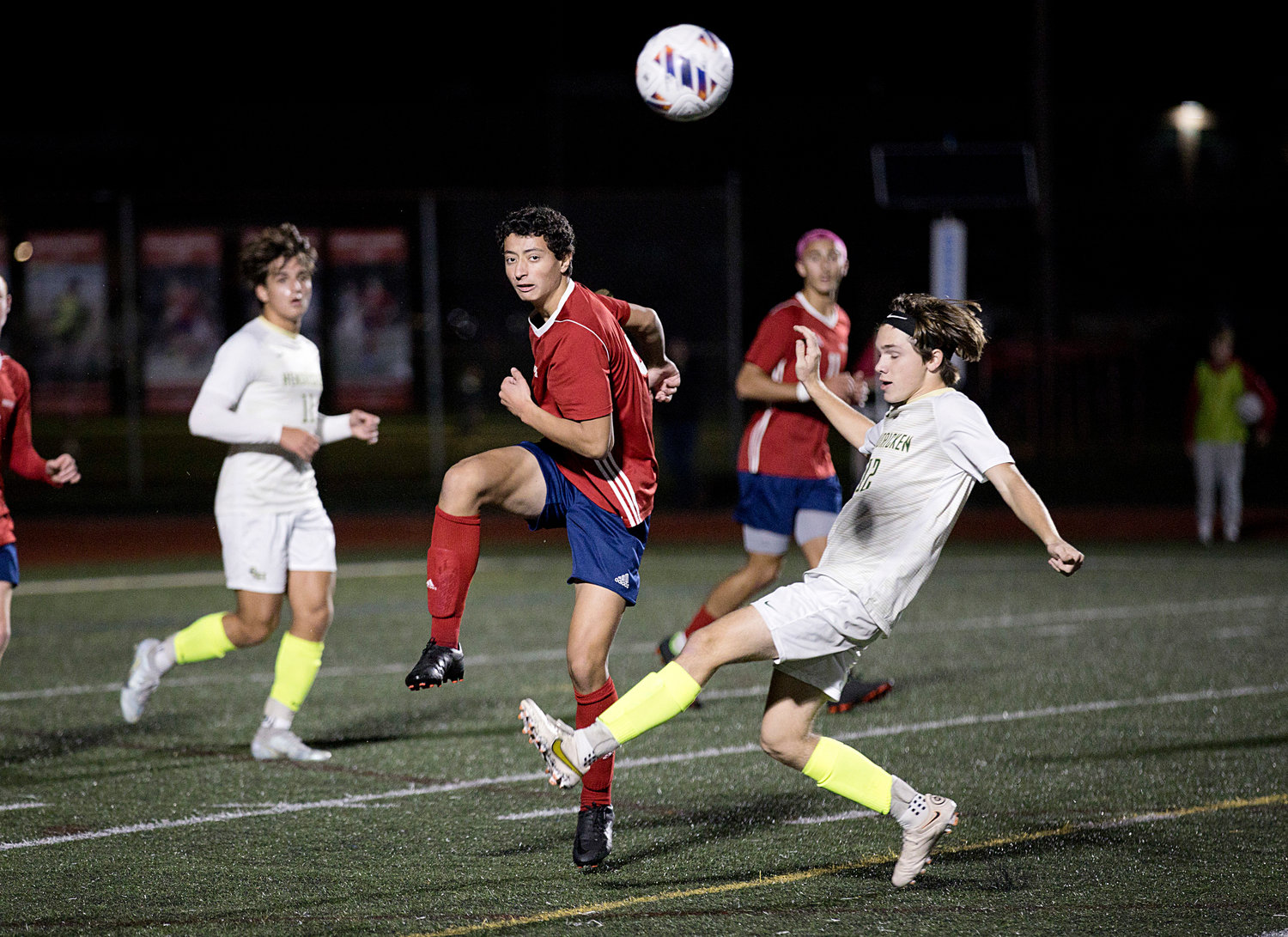 Ferenc Karoly boots the ball past a Hendricken opponent.