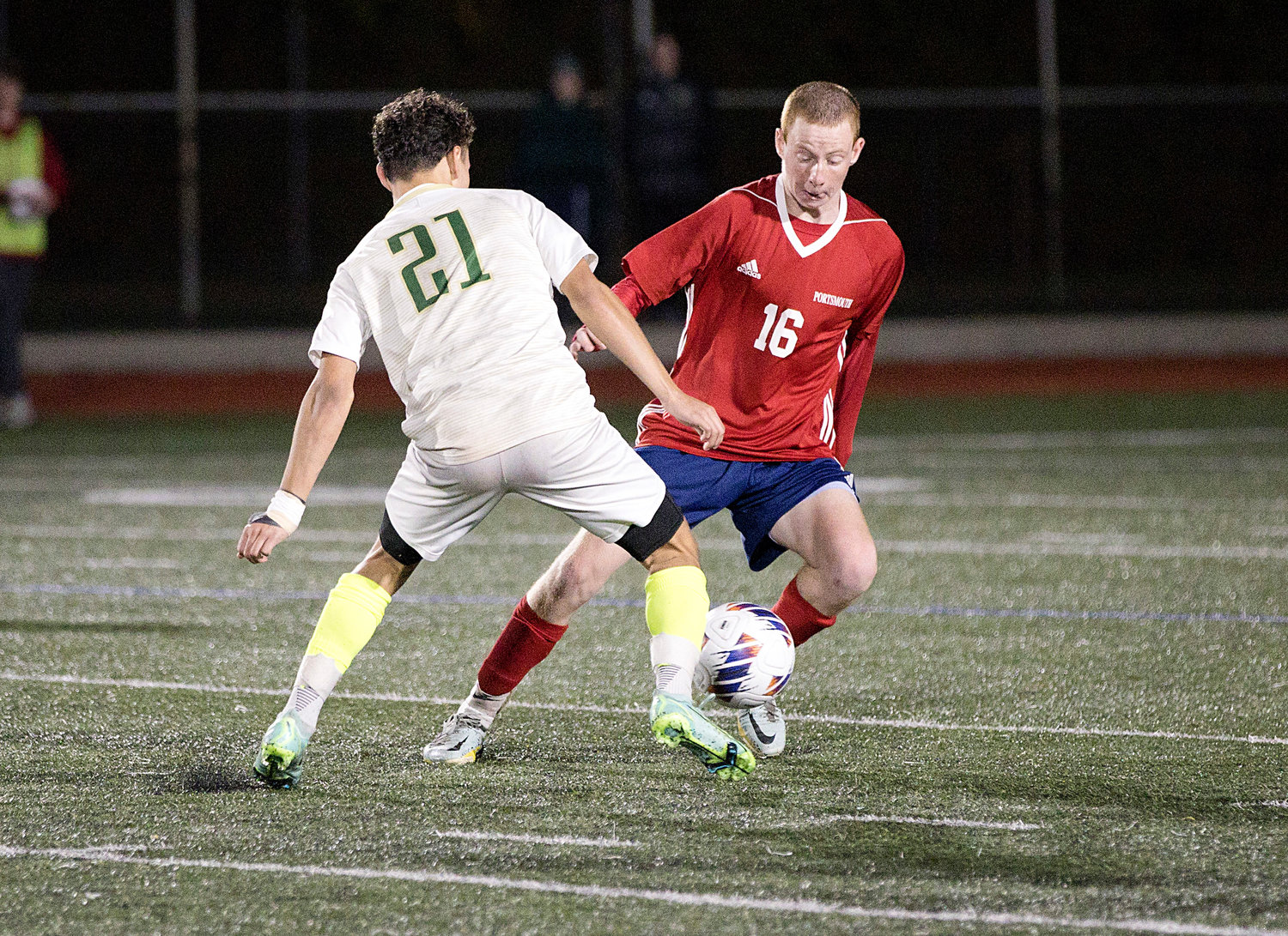 Jacob Rooney battles a Bishop Hendricken opponent for possession of the ball.