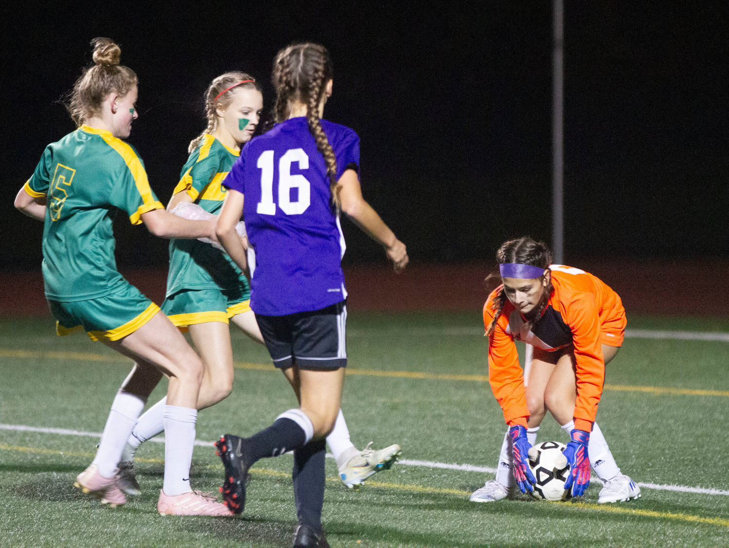 Goalkeeper Mekayla Nieves bends over to collect a weak shot by Gallagher in the final minutes of the game.
