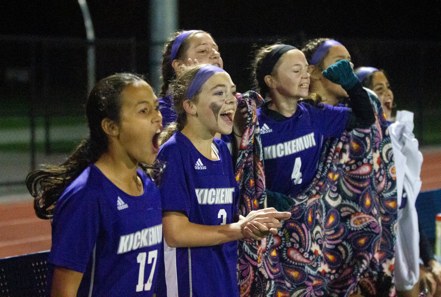 Maya Goglia (left), Ava Morissette, Norah Francis, Catherine Frawley and others cheer on their teammates from the bench.