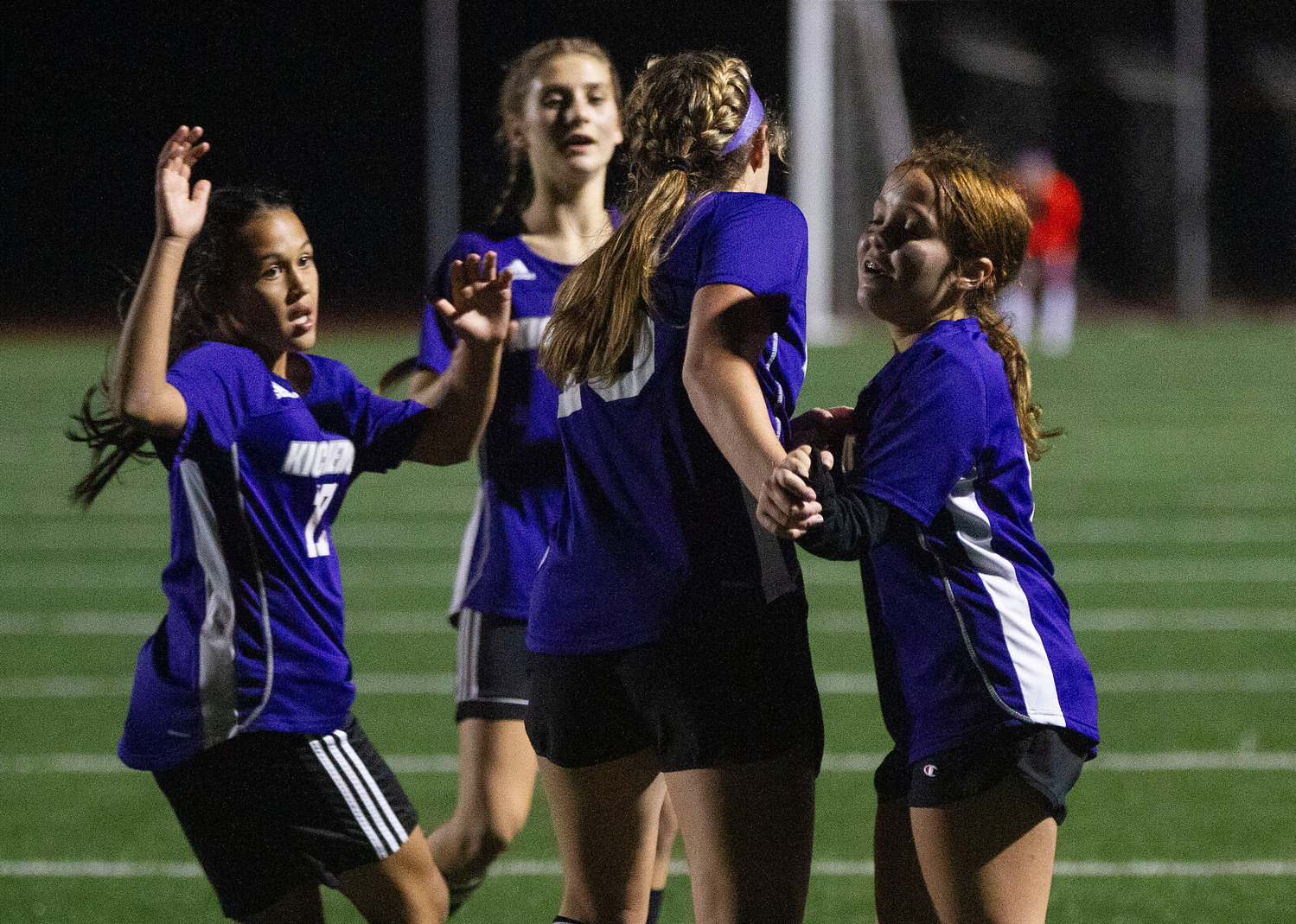 Thalia Adkins (left), Angela Pirri (right) and another teammate celebrate with Sara Nencka after she scored an insurance goal in the second half.
