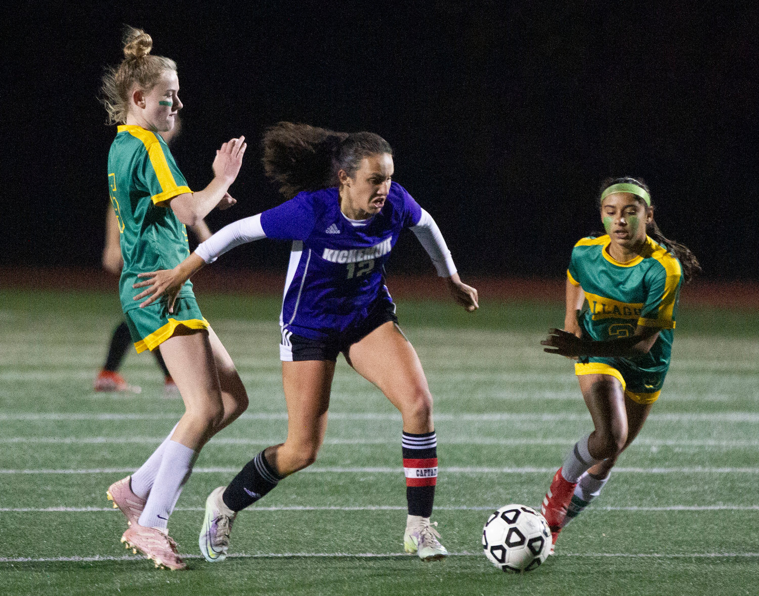 Emma Goglia dribbles between two Gallagher defenders during a Huskies attack.