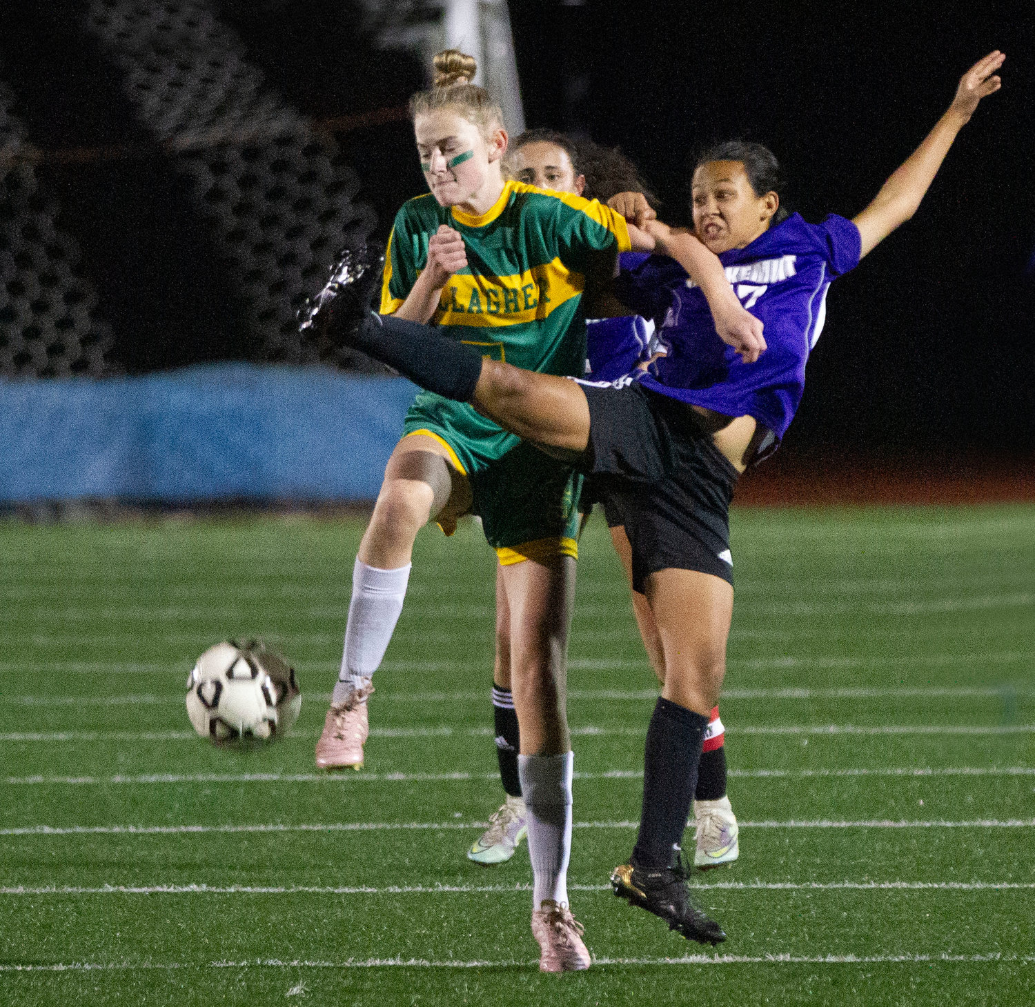 Maya Goglia is thrown to the ground by a Gallagher player while attempting to knock down a goal kick.