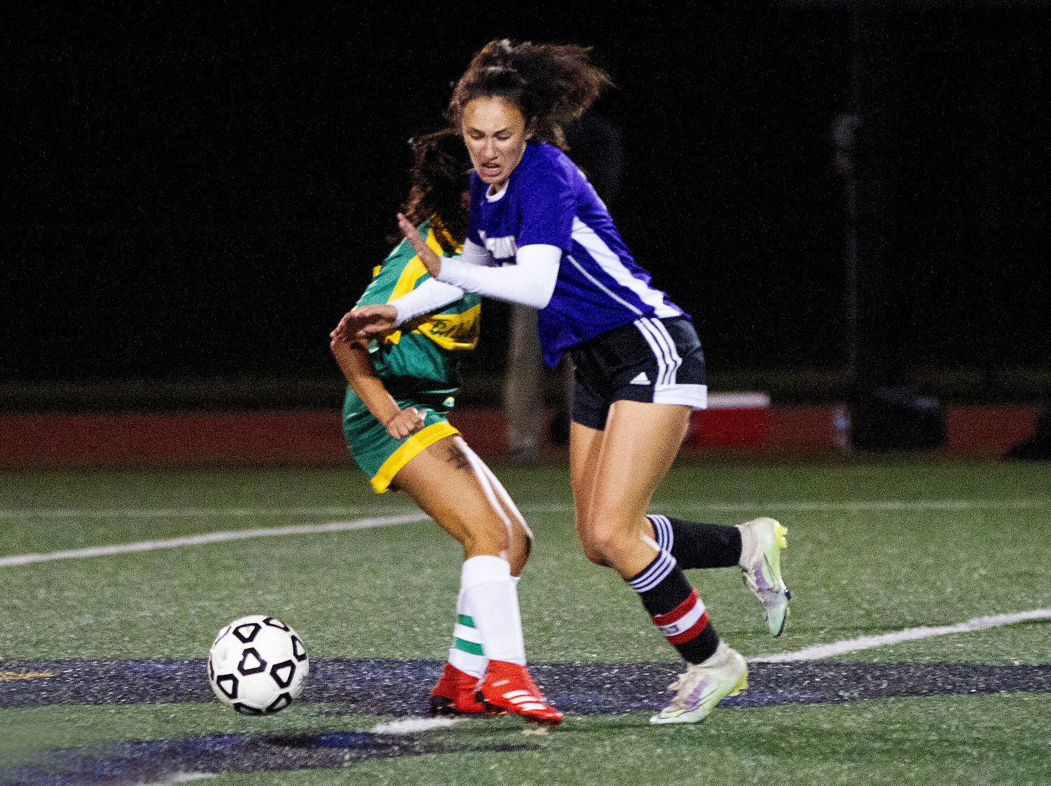 Emma Goglia fights for a loose ball at midfield.