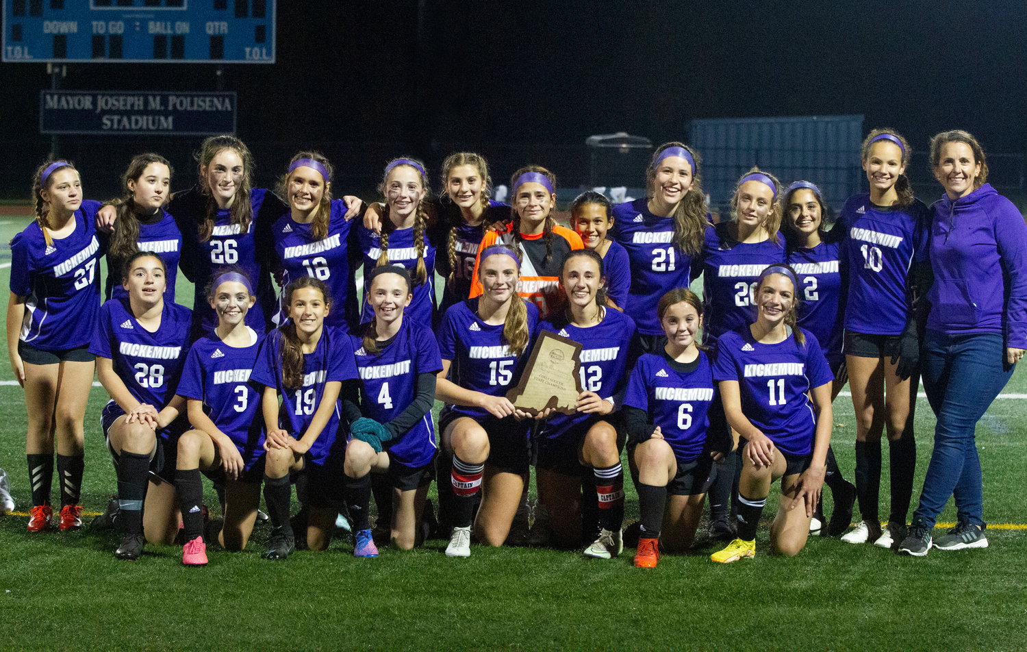 The Kickemuit Middle School girls soccer team poses for family and friends in the crowd.