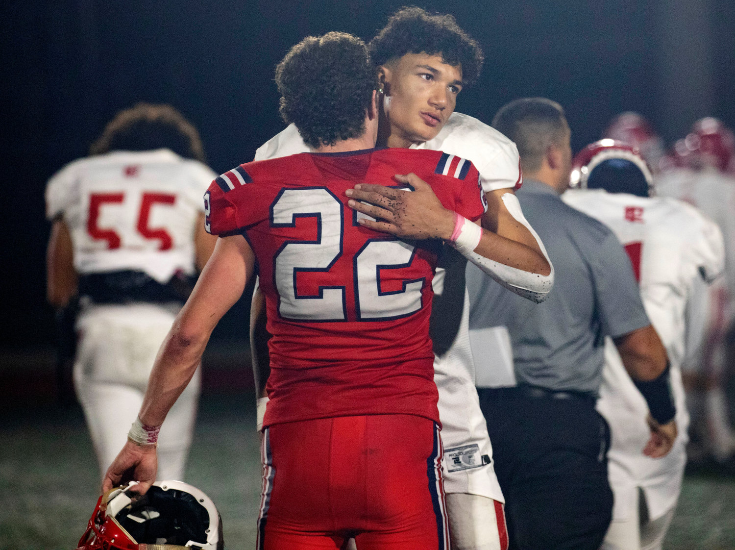 Portsmouth linebacker Dylan Brandariz, who terrorized the townies on defense, connects with Townies quarterback Maxwell Whiting after the game.