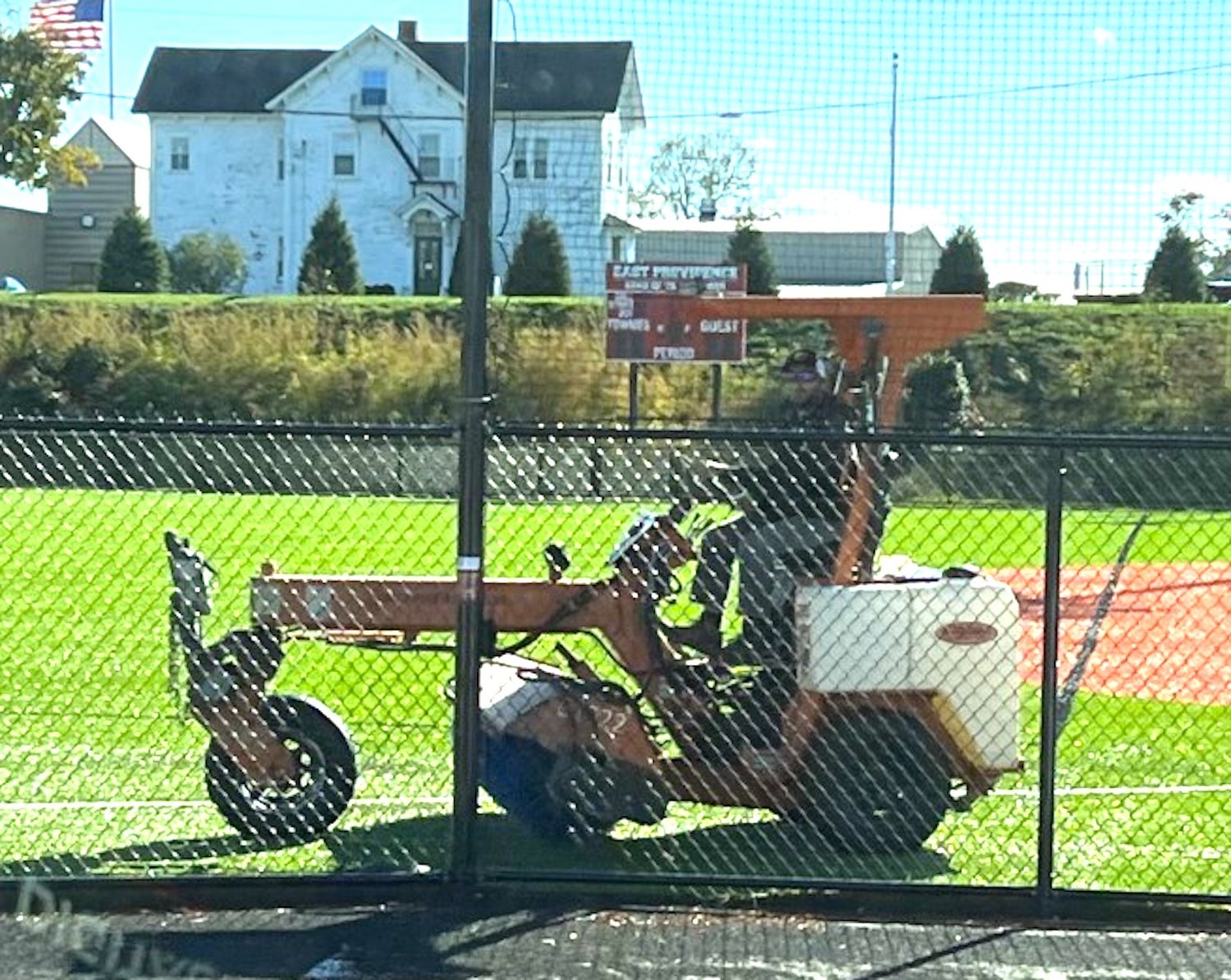A worker brushes the new artificial turf softball field at EPHS.